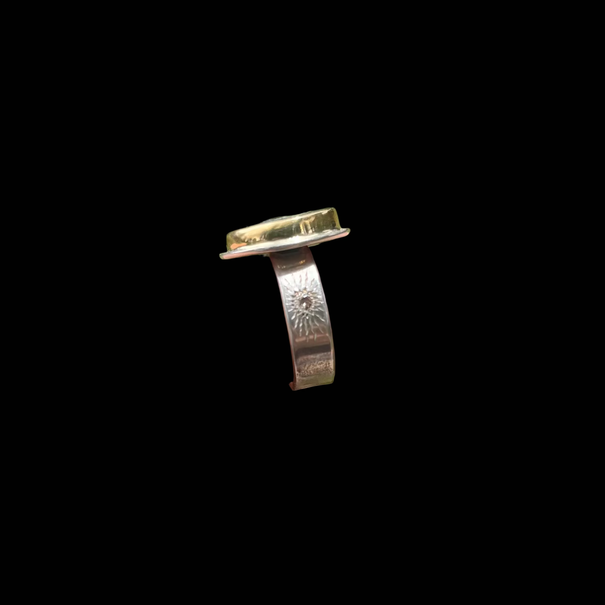 side view of ring on black background