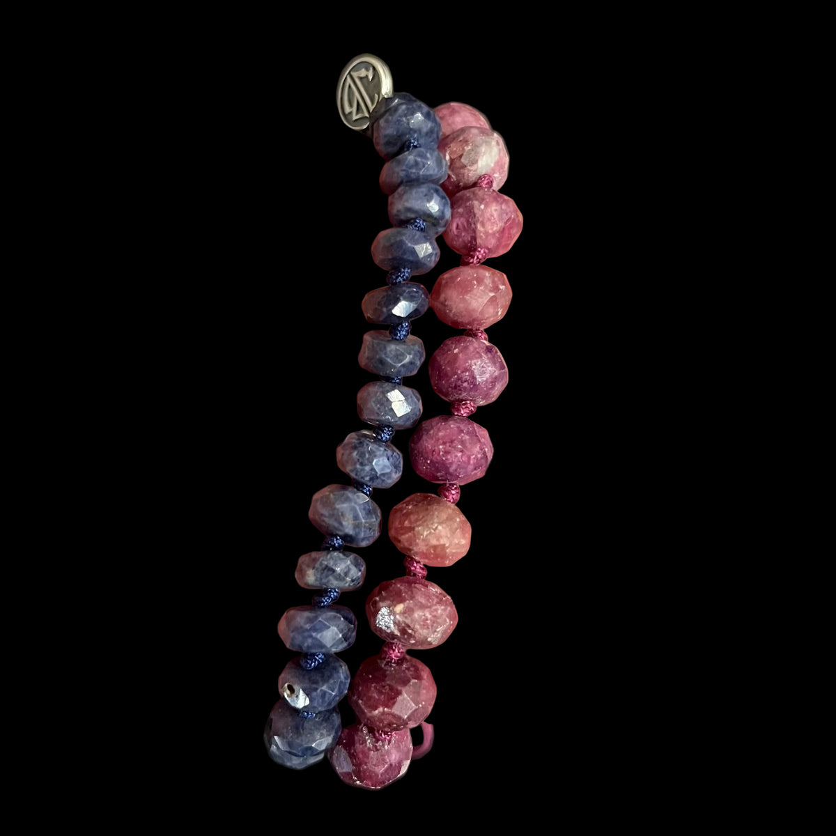 Black and pink stone bracelets shown side by side 