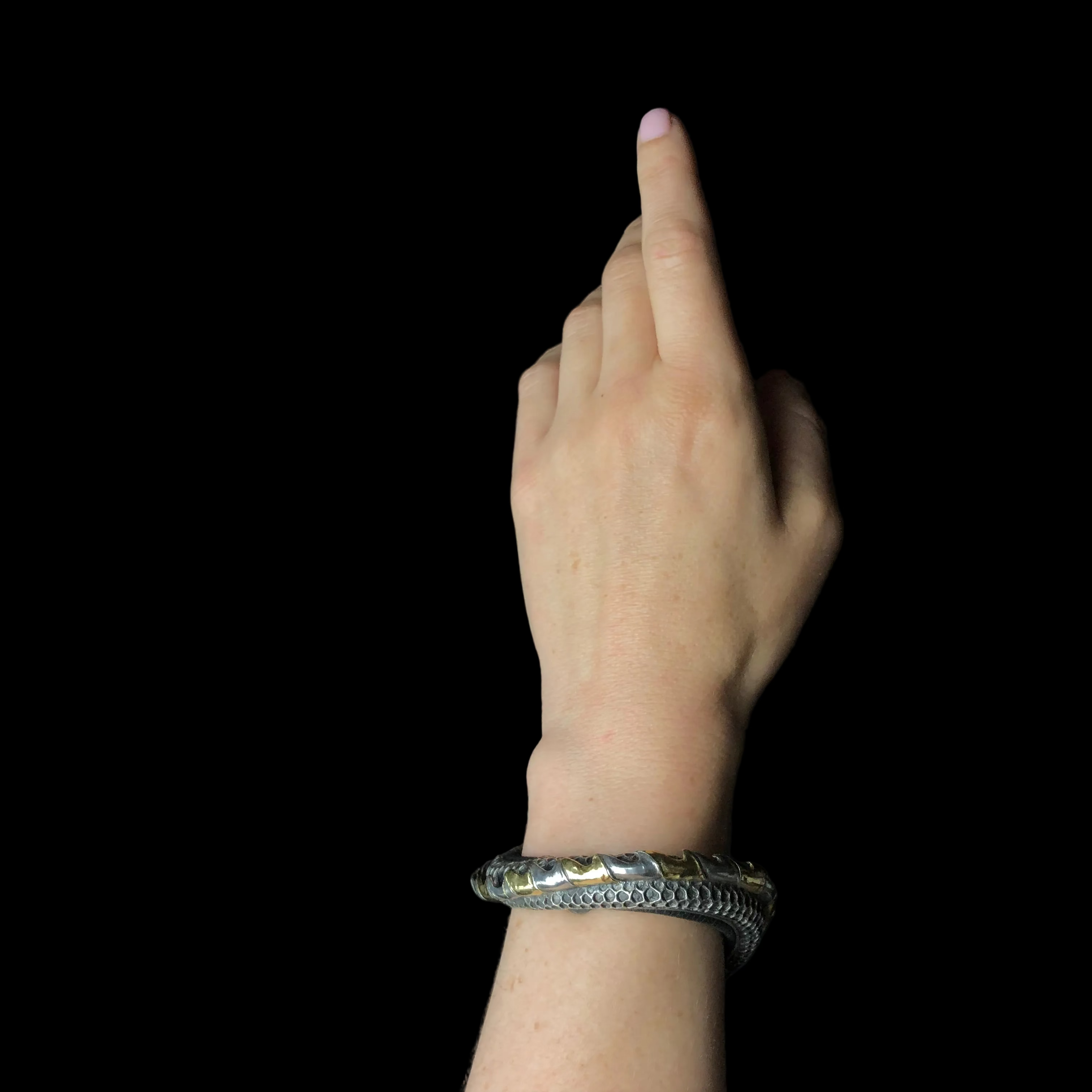 Hand with a bracelet on a black background