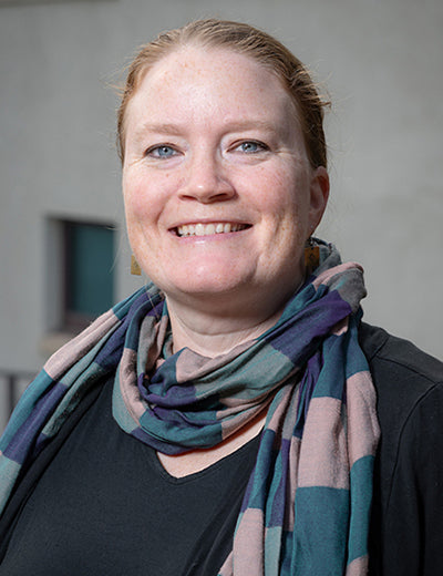 photo of blue eyed Dr. Margaret Gaida wearing scarf wrapped around her neck
