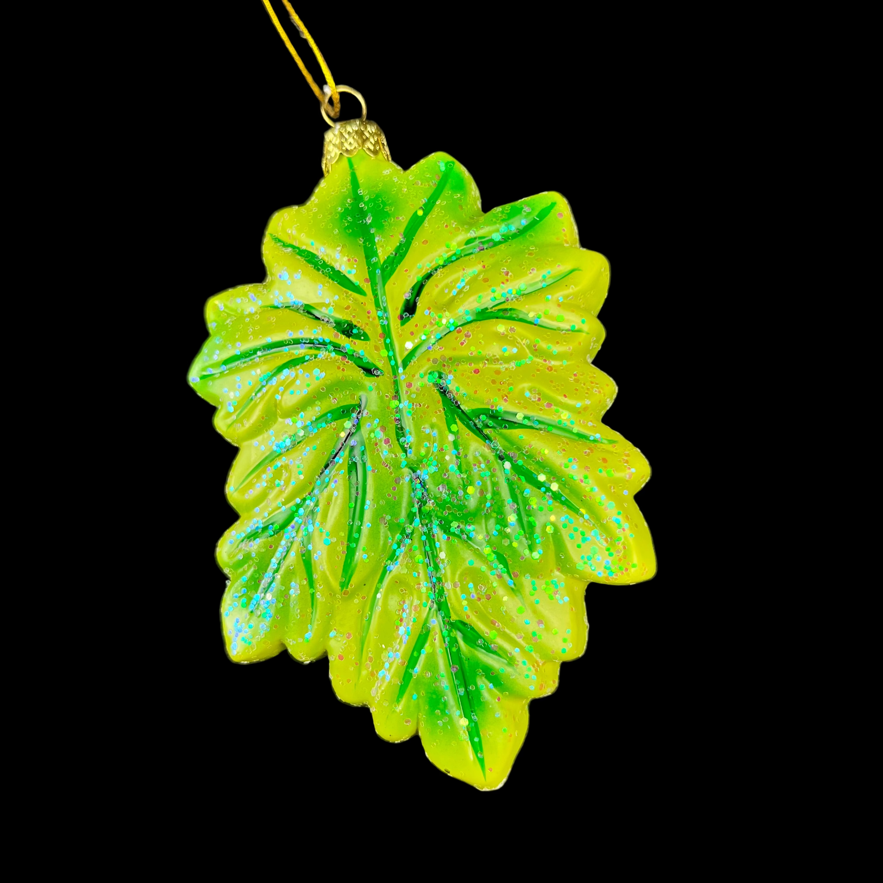 Green leaf-shaped ornament on a dark background