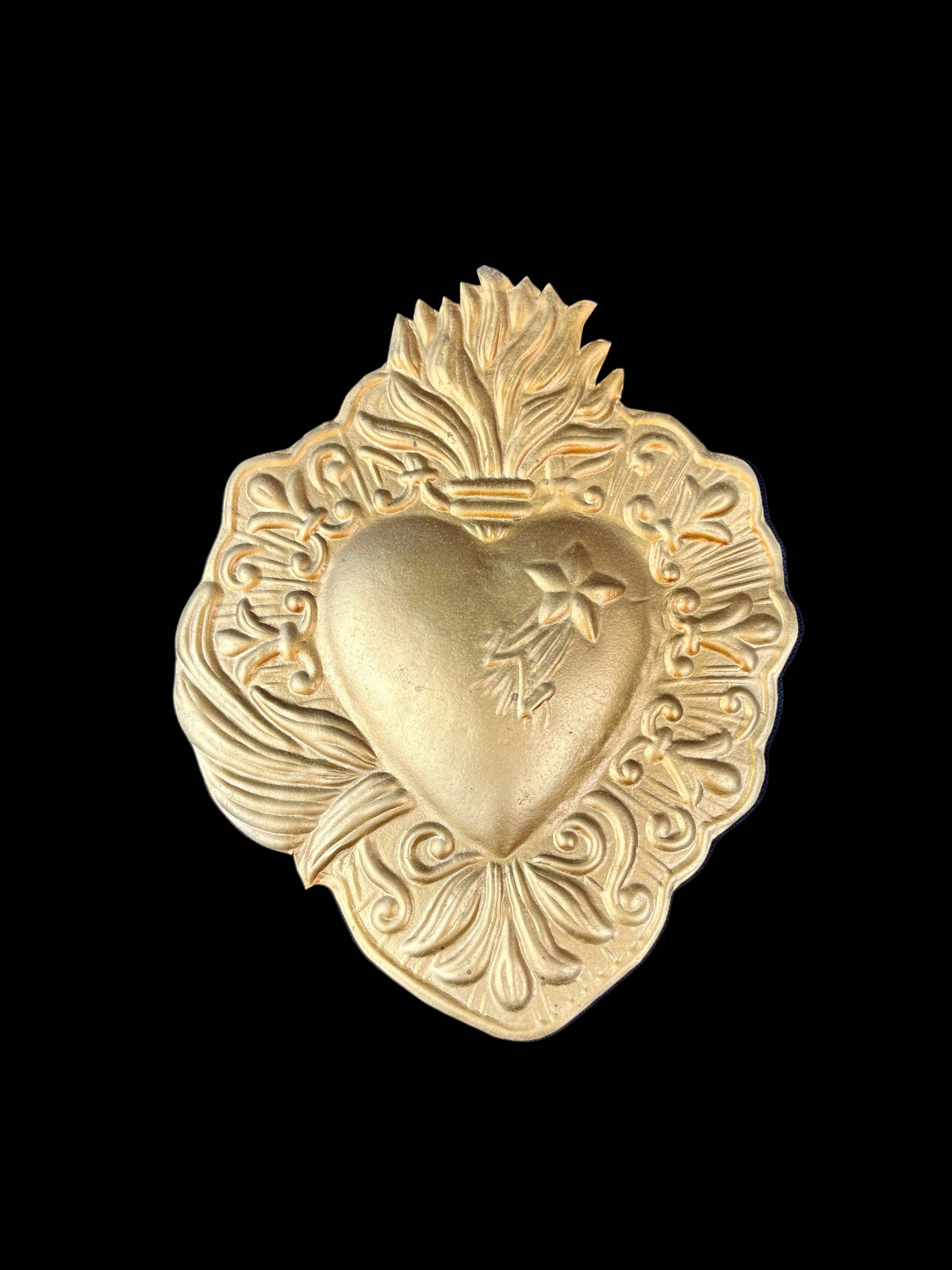 Heart Shaped Golden Metal relief on black background 