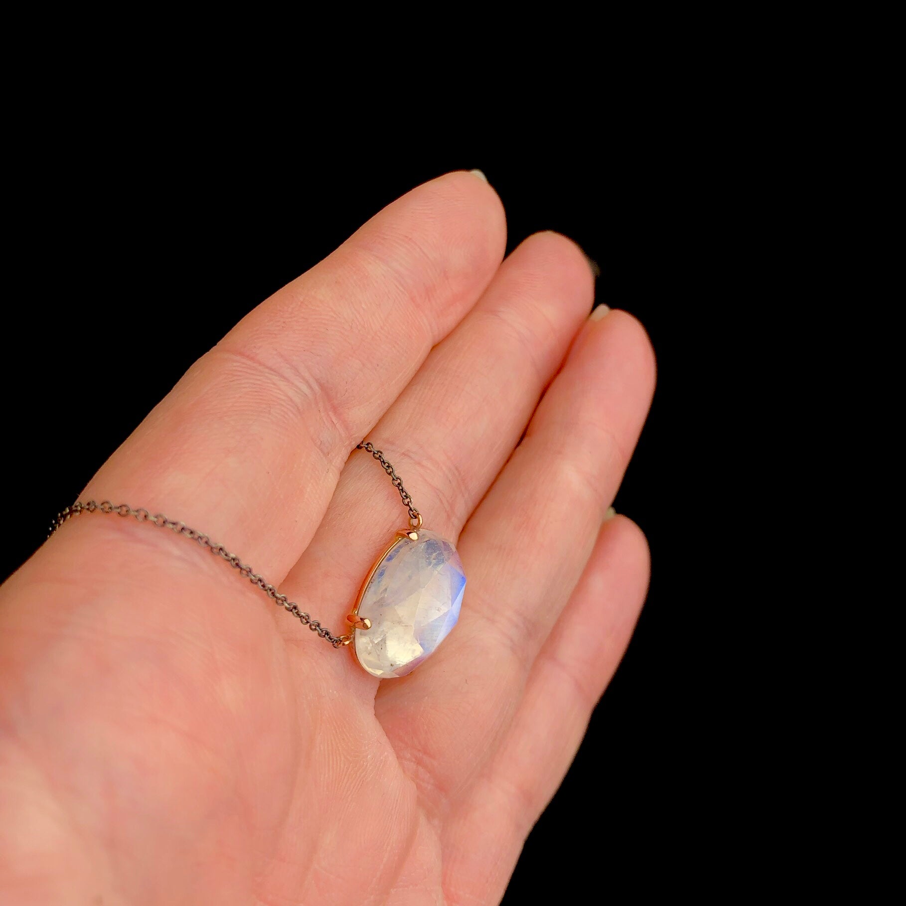 Top view of Rainbow Moonstone Necklace with prong setting of faceted stone