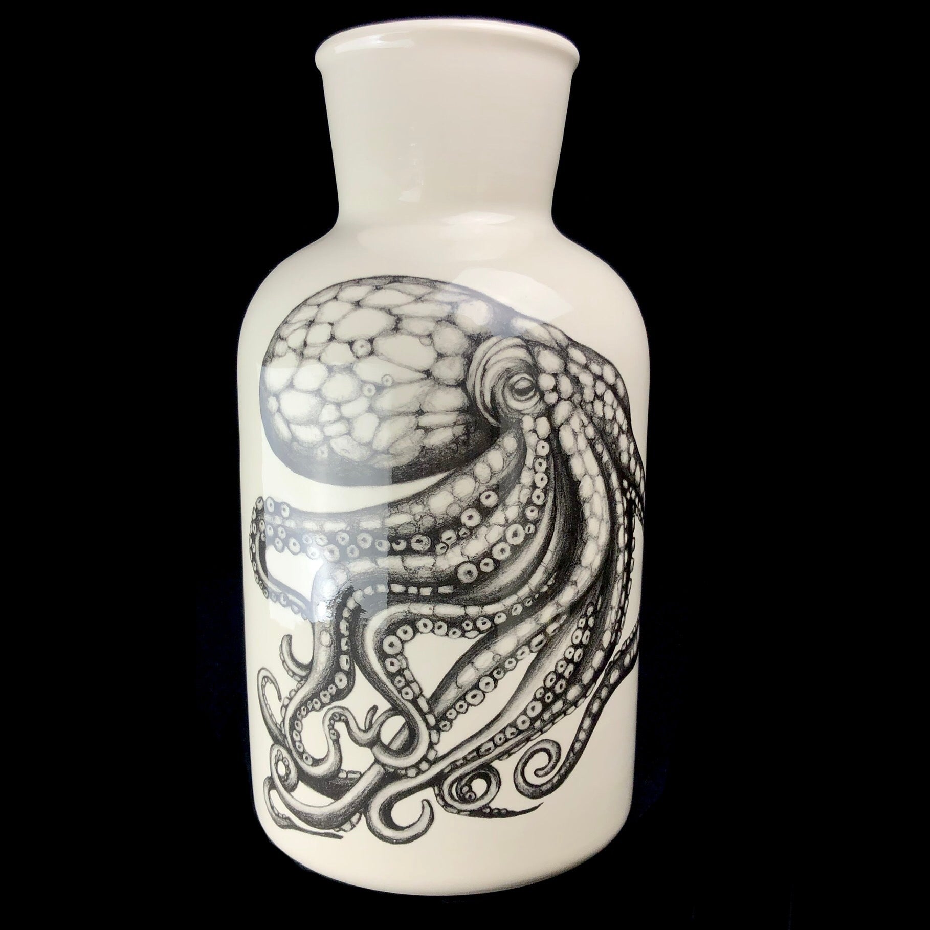 White case with black drawing of a large octopus