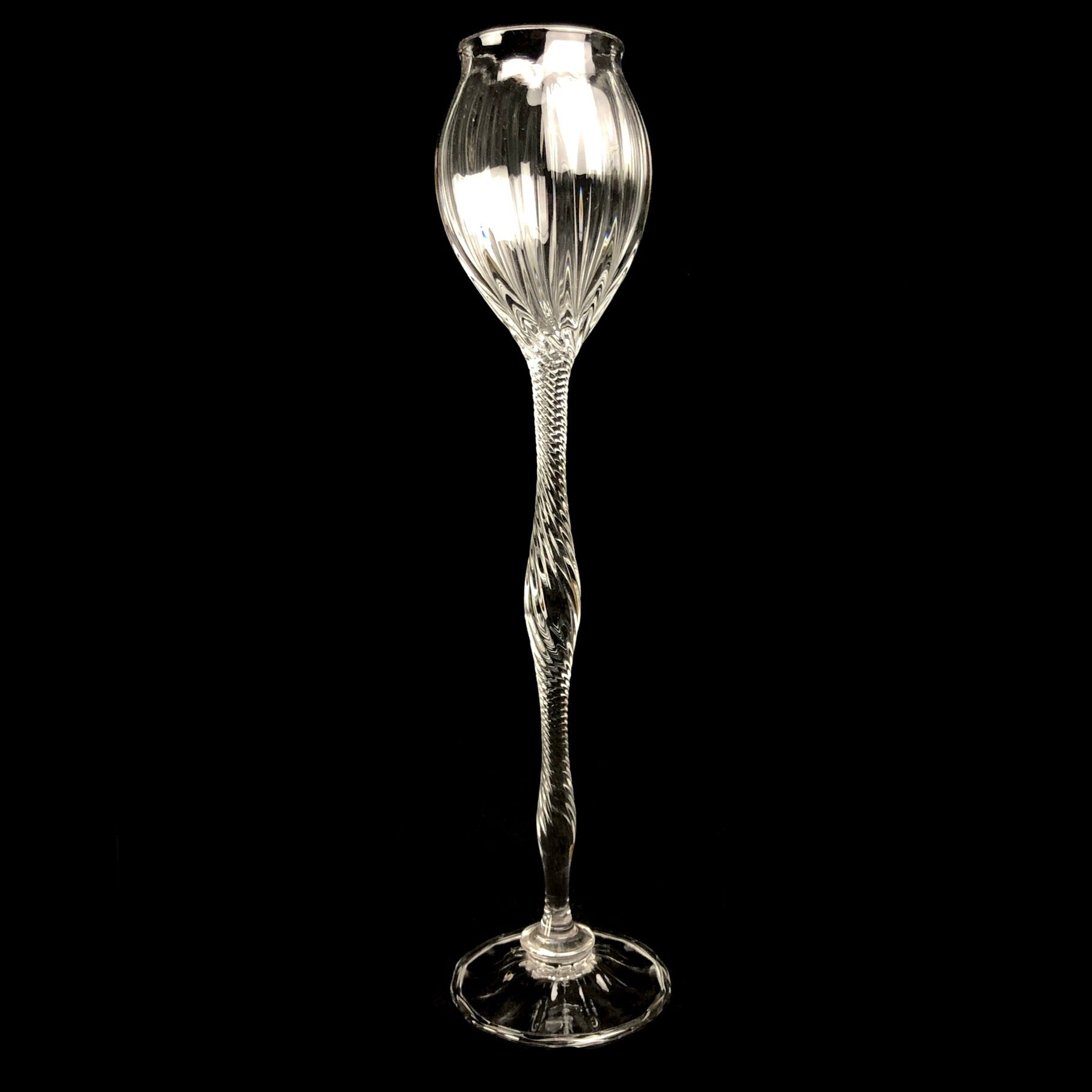 Clear glass goblet with ornate stem