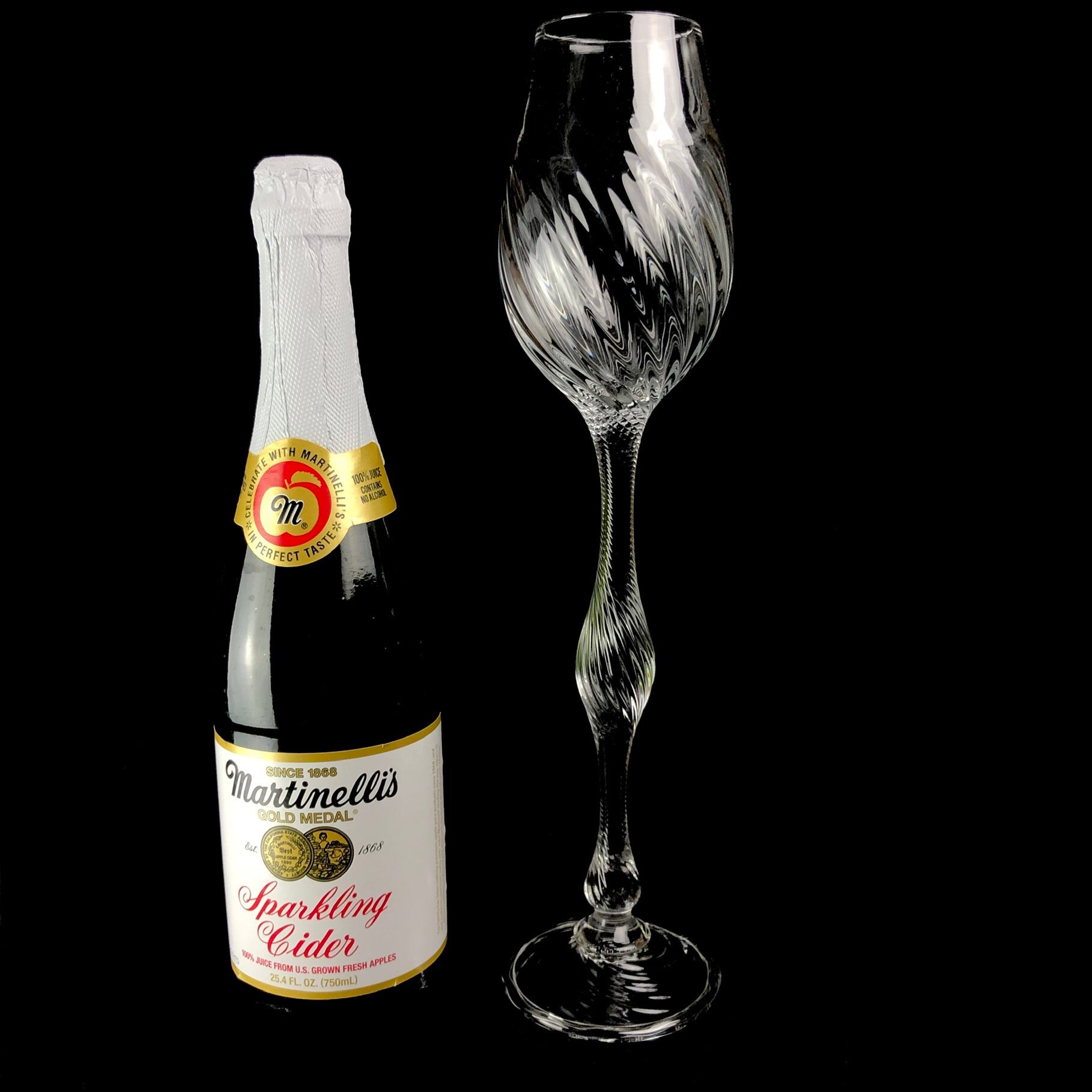 Oversized Glass Goblet shown sitting beside a standard champagne bottle