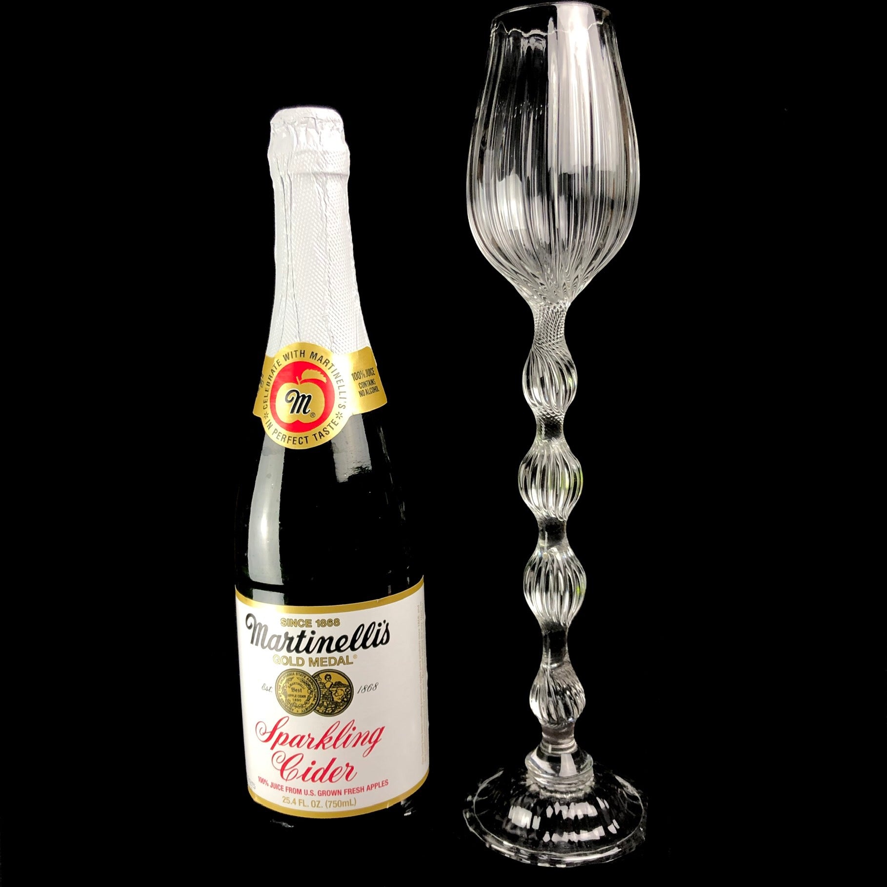 Oversized Glass Goblet shown sitting beside a standard champagne bottle