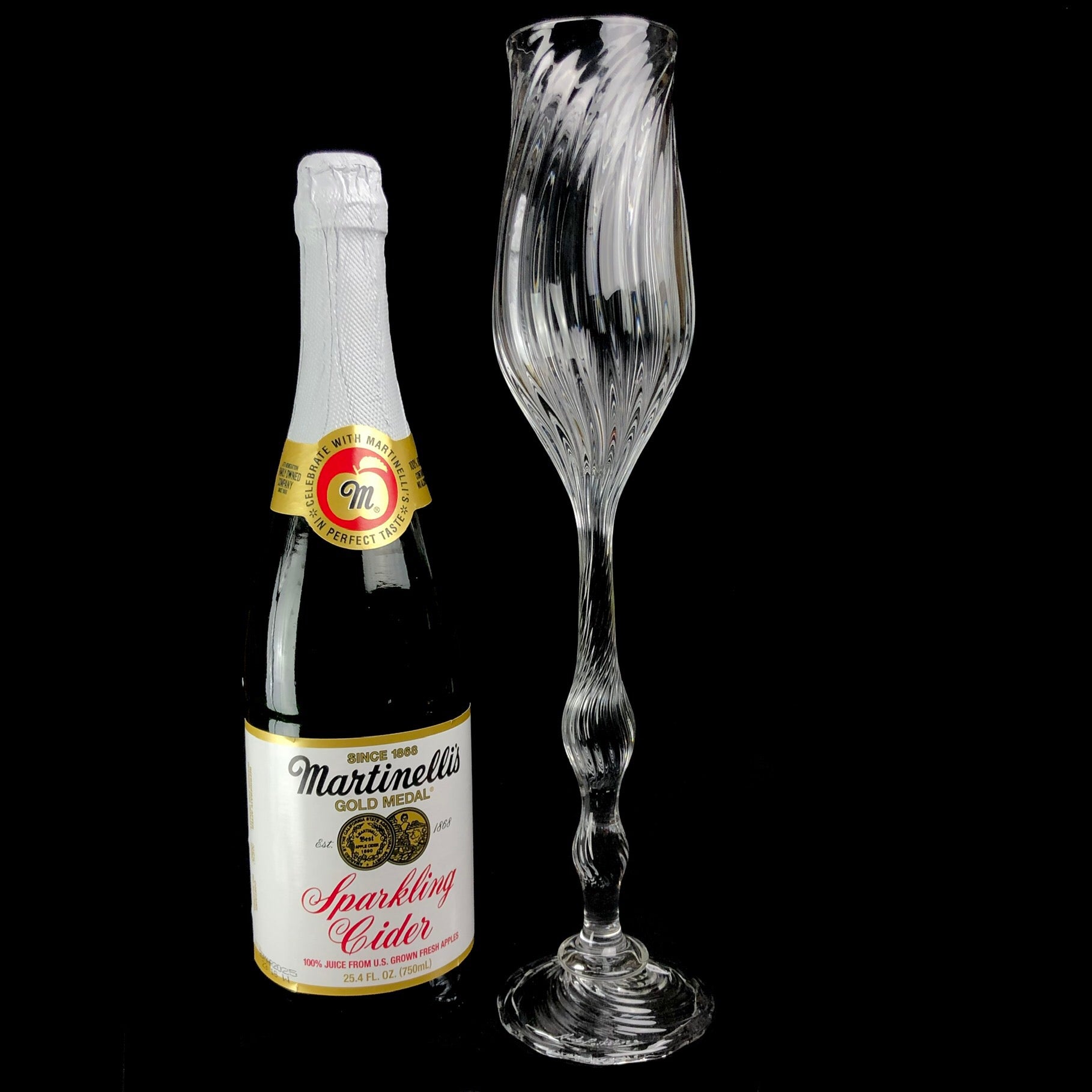 Oversized Glass Goblet shown sitting beside a standard champagne bottle