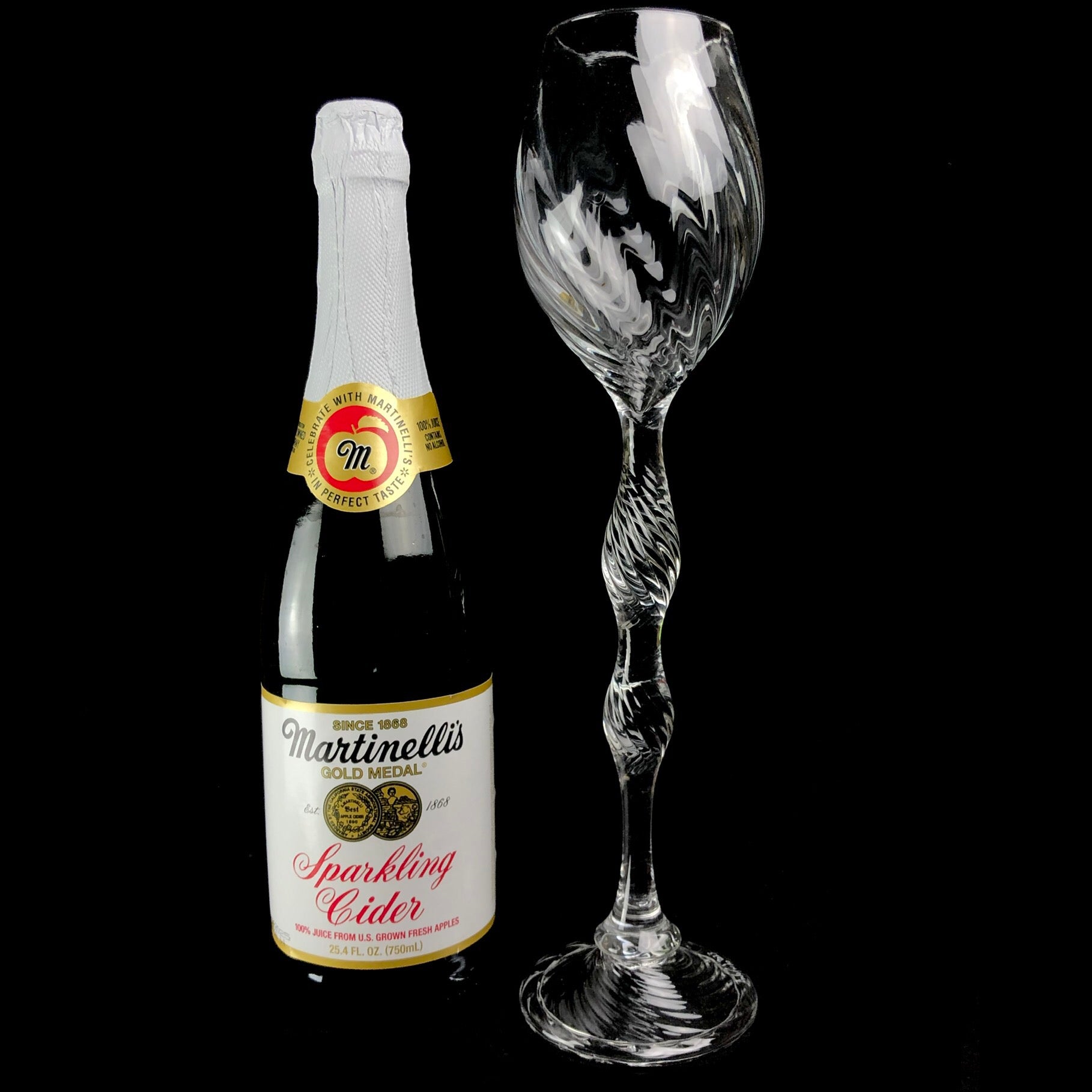 Oversized Glass Goblet shown sitting beside a standard champagne bottle