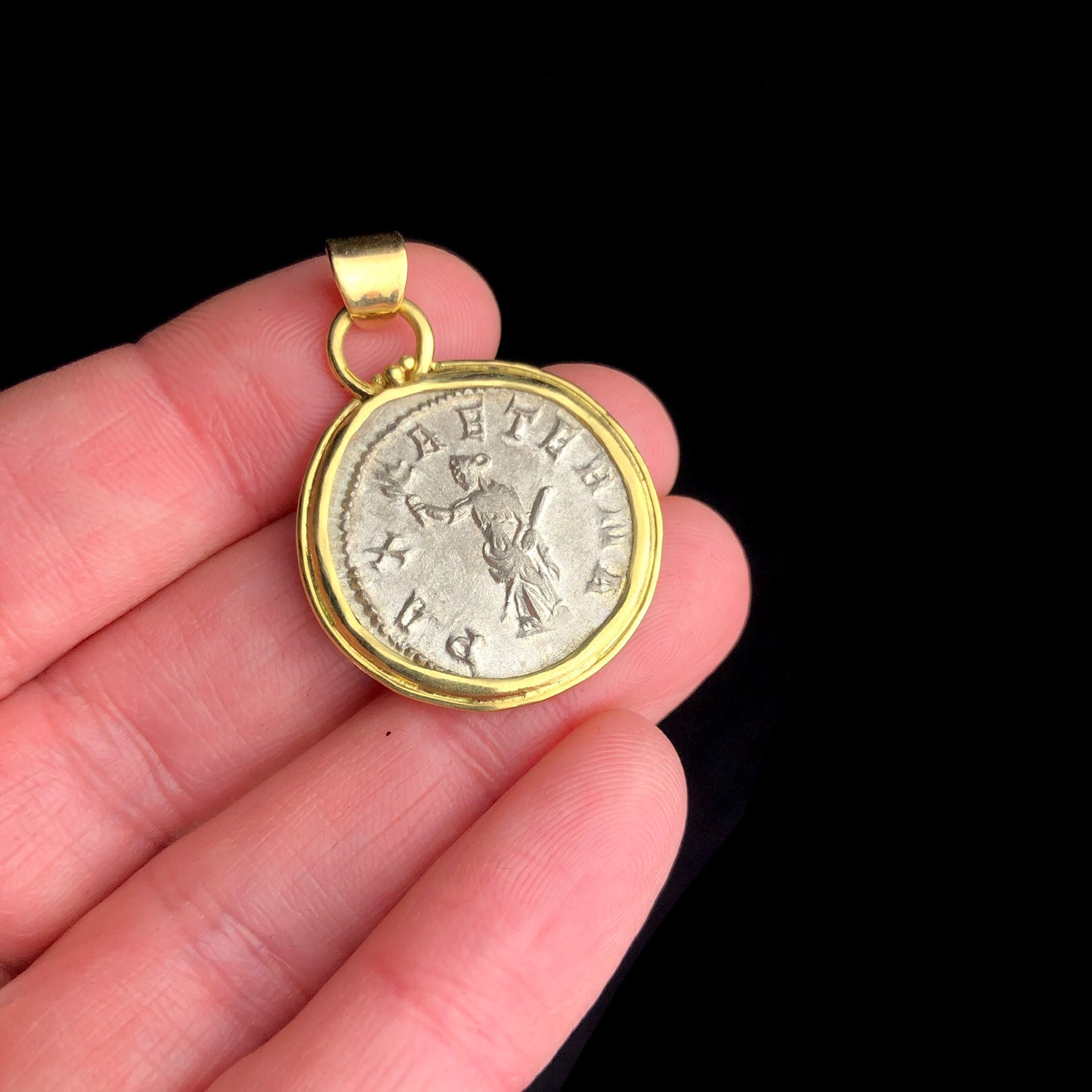 Goddess of Peace Coin Pendent shown in hand