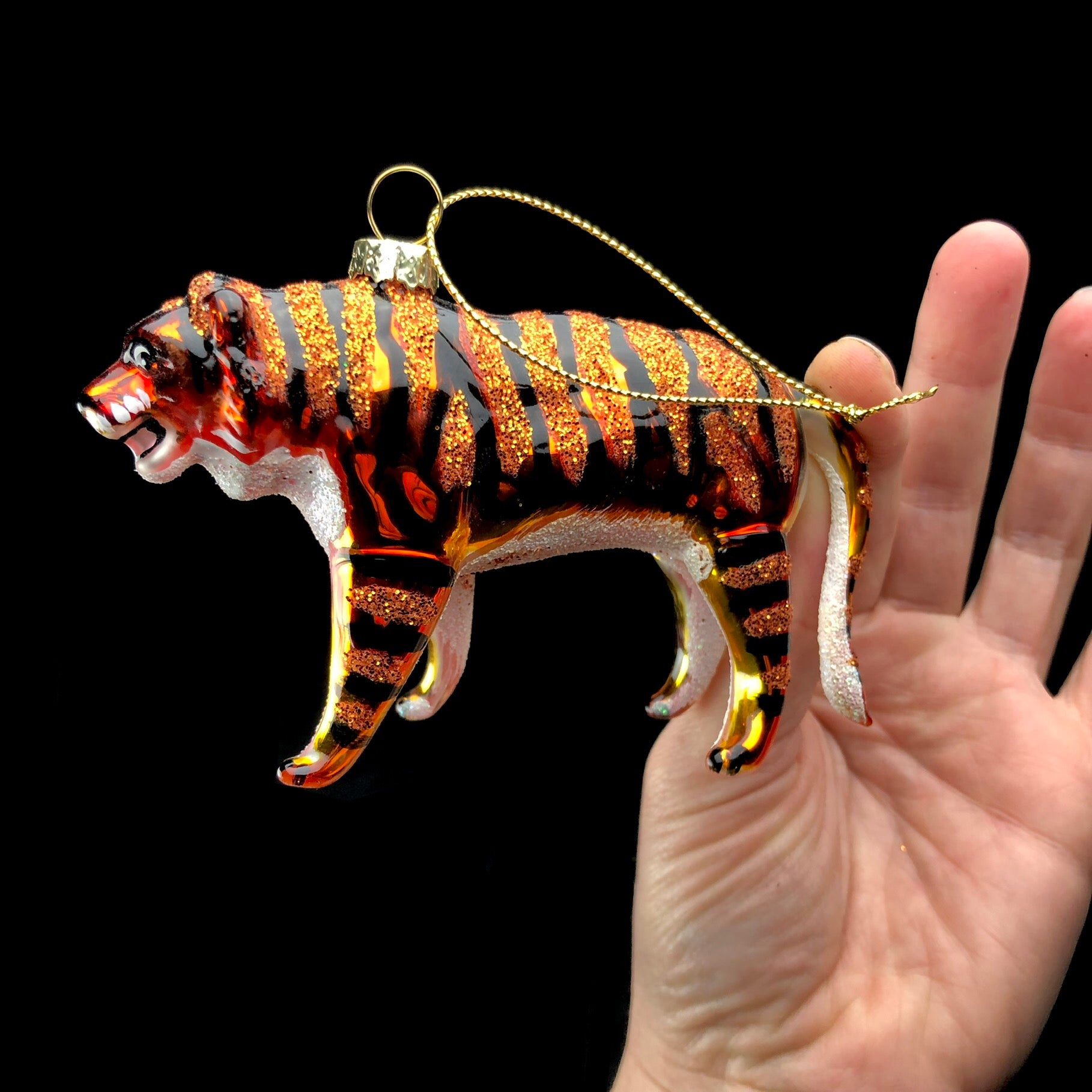 Orange glass Tiger Ornament held in hand