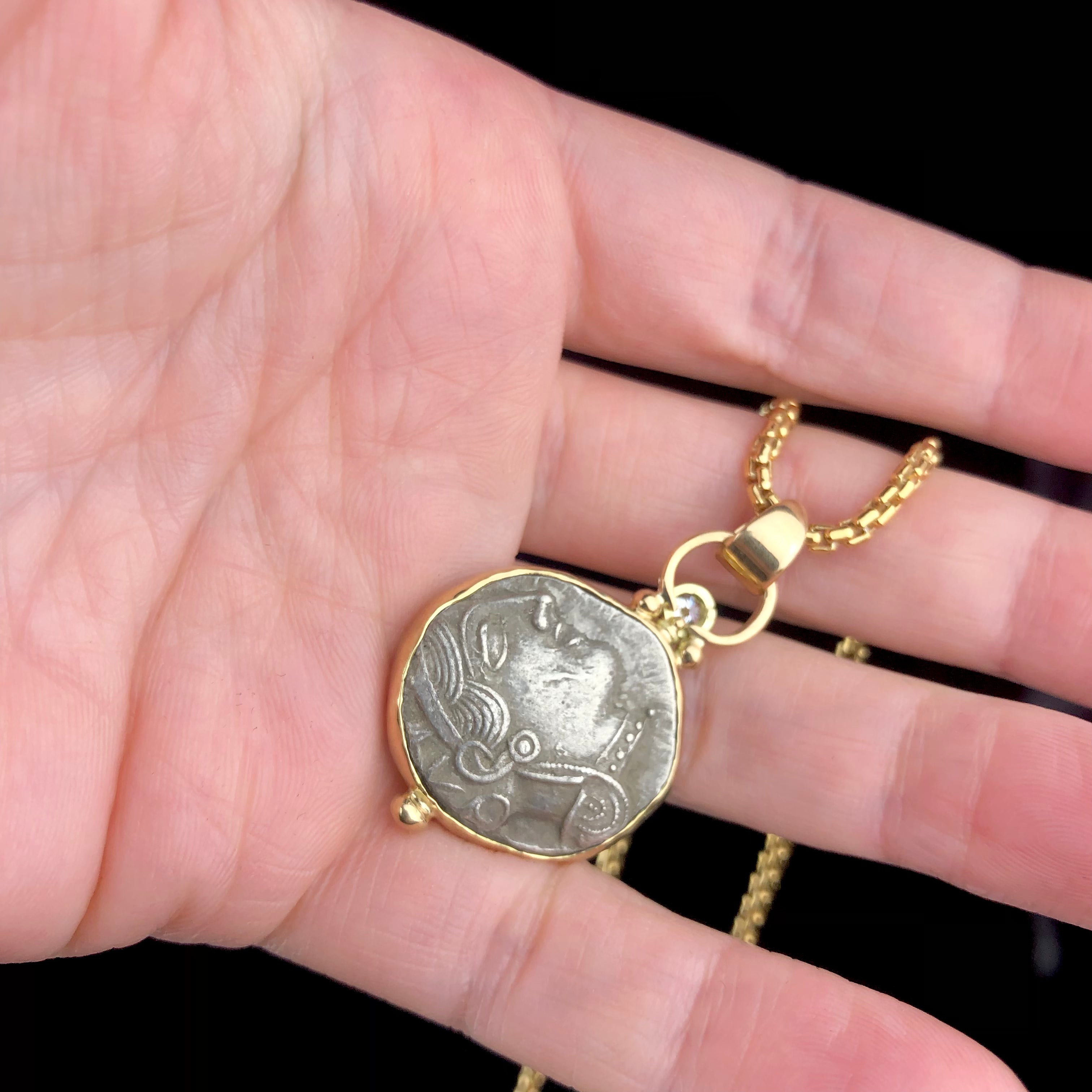 Athena Tetradrachm Coin Pendent shown in hand