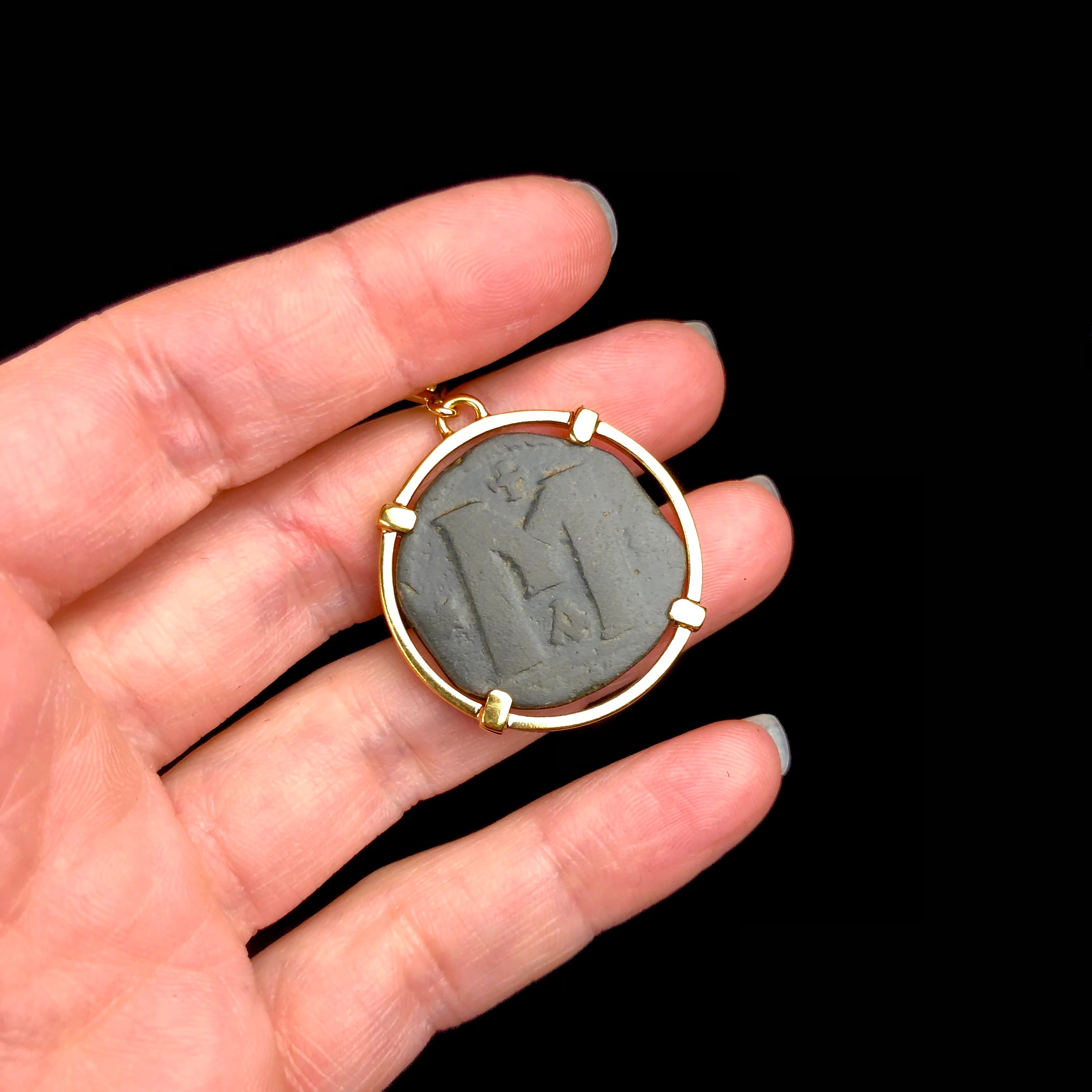 Back of Byzantine Coin Pendent with letter M shown in hand