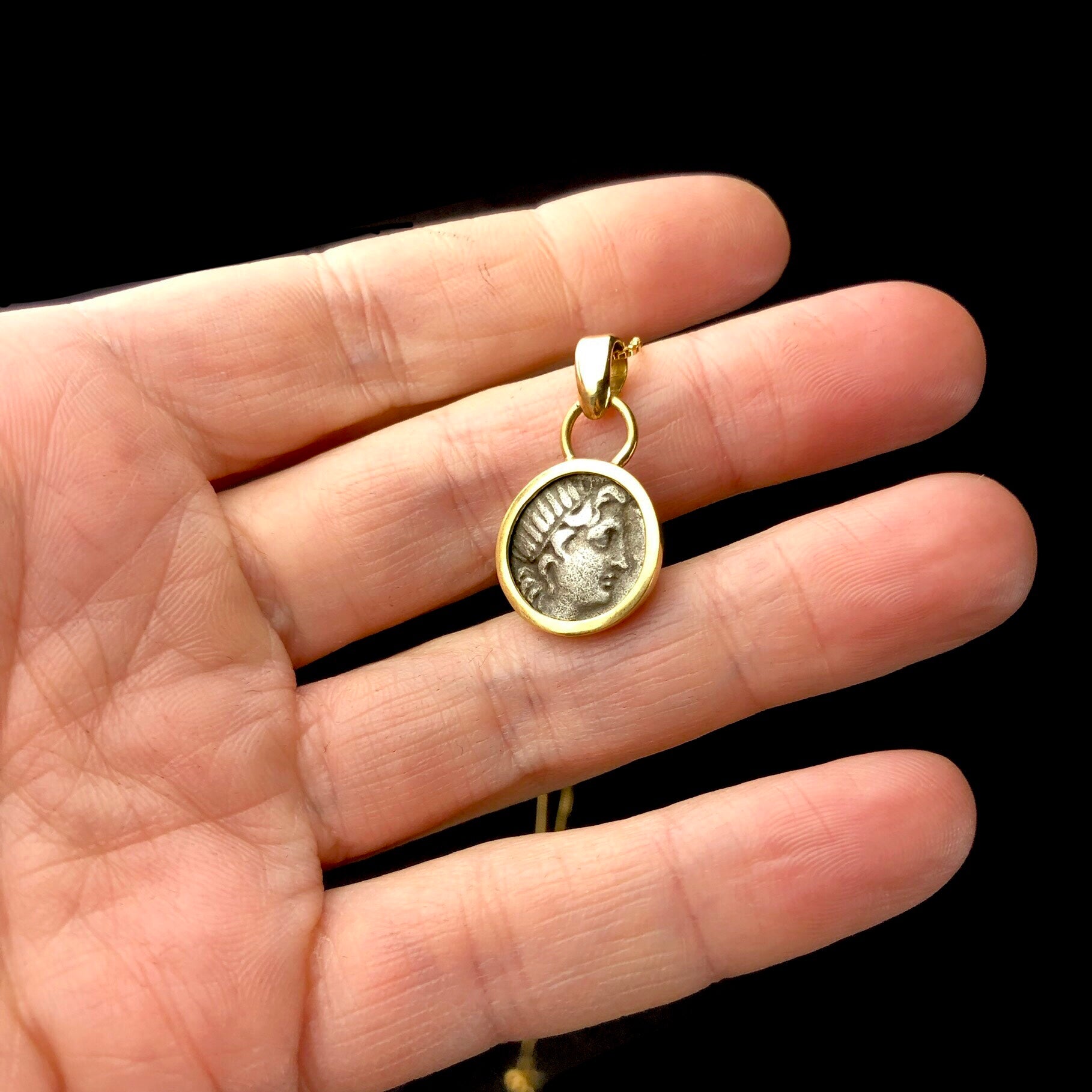 Helios Coin Pendent shown in hand