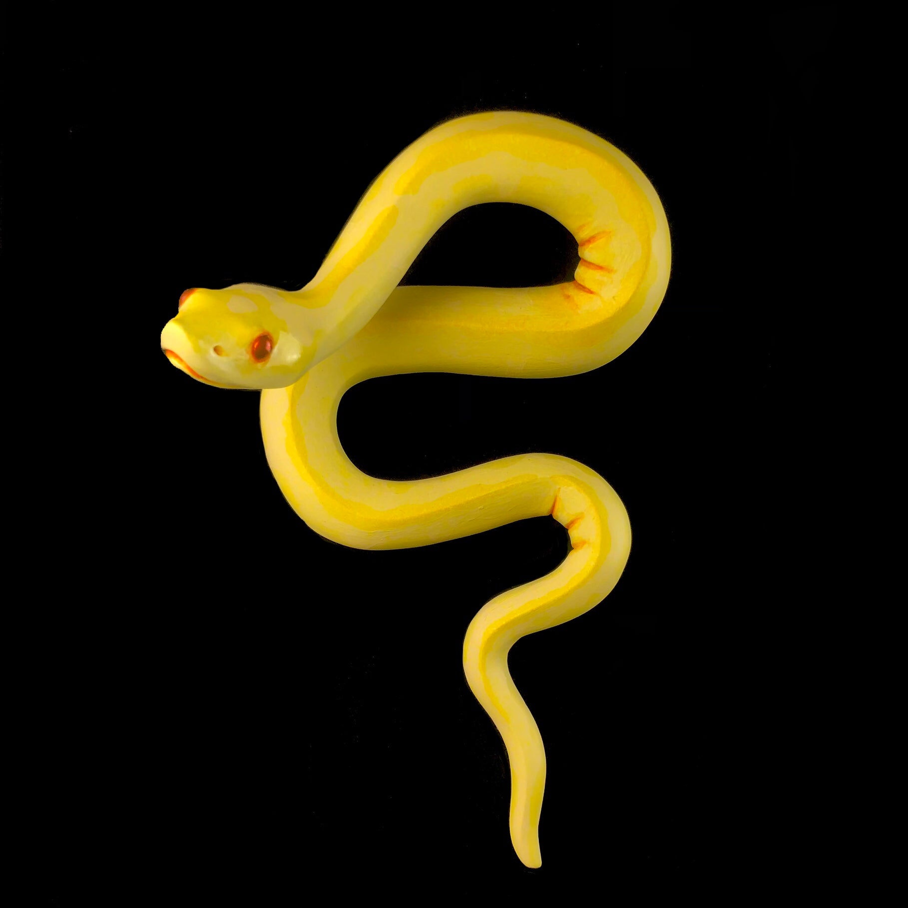 Front view of Yellow Snake Sculpture hanging on wall