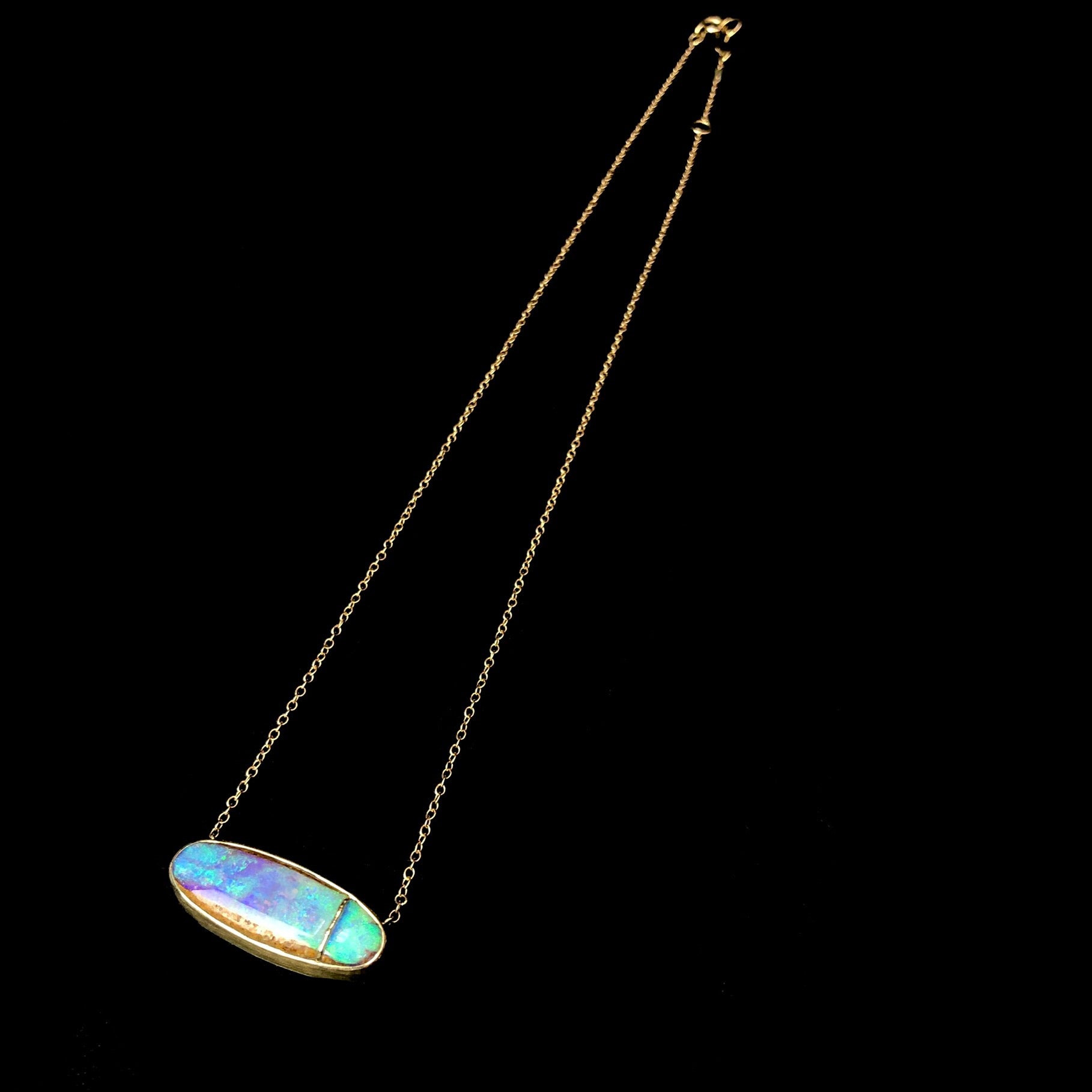 Full view of Opalized Wood Necklace with depth of greens and blues in the stone