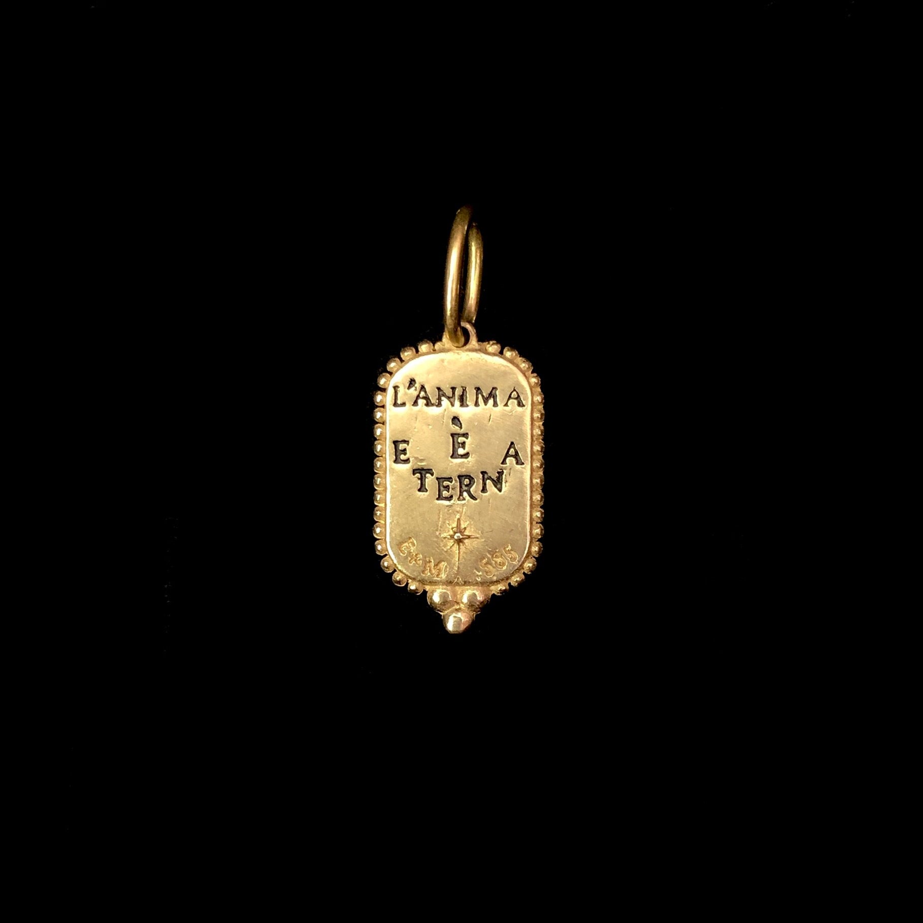 Back view of Small Man in the Moon Charm with impressed words L'ANIMA E ETERNA