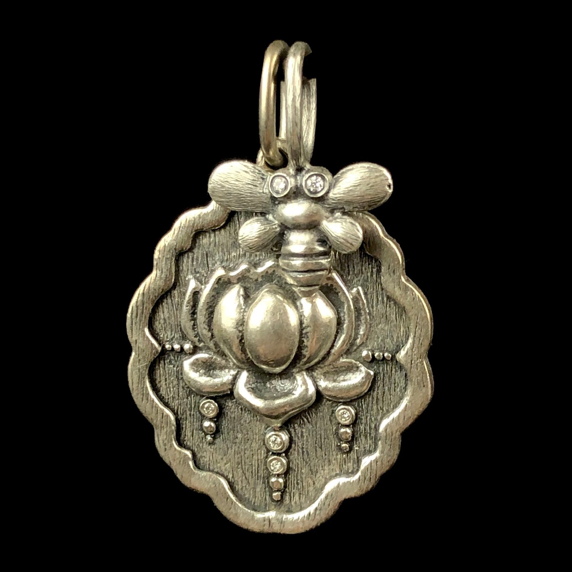 Nameste charm paired with diamond eye bee charm