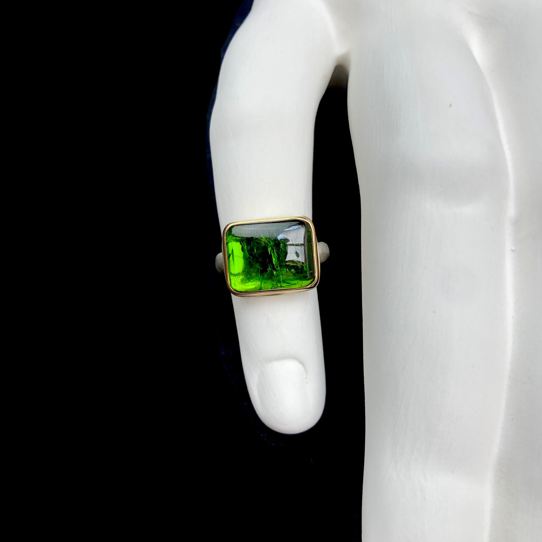 Front top view of Green Tourmaline Ring on white ceramic finger
