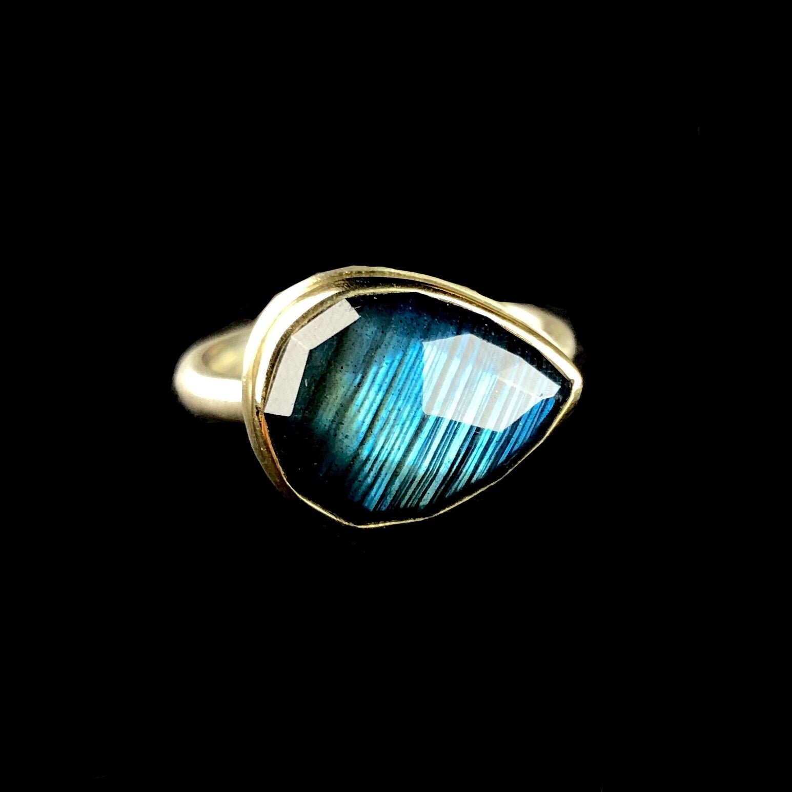 Teardrop shaped blue/green iridescent stone ring