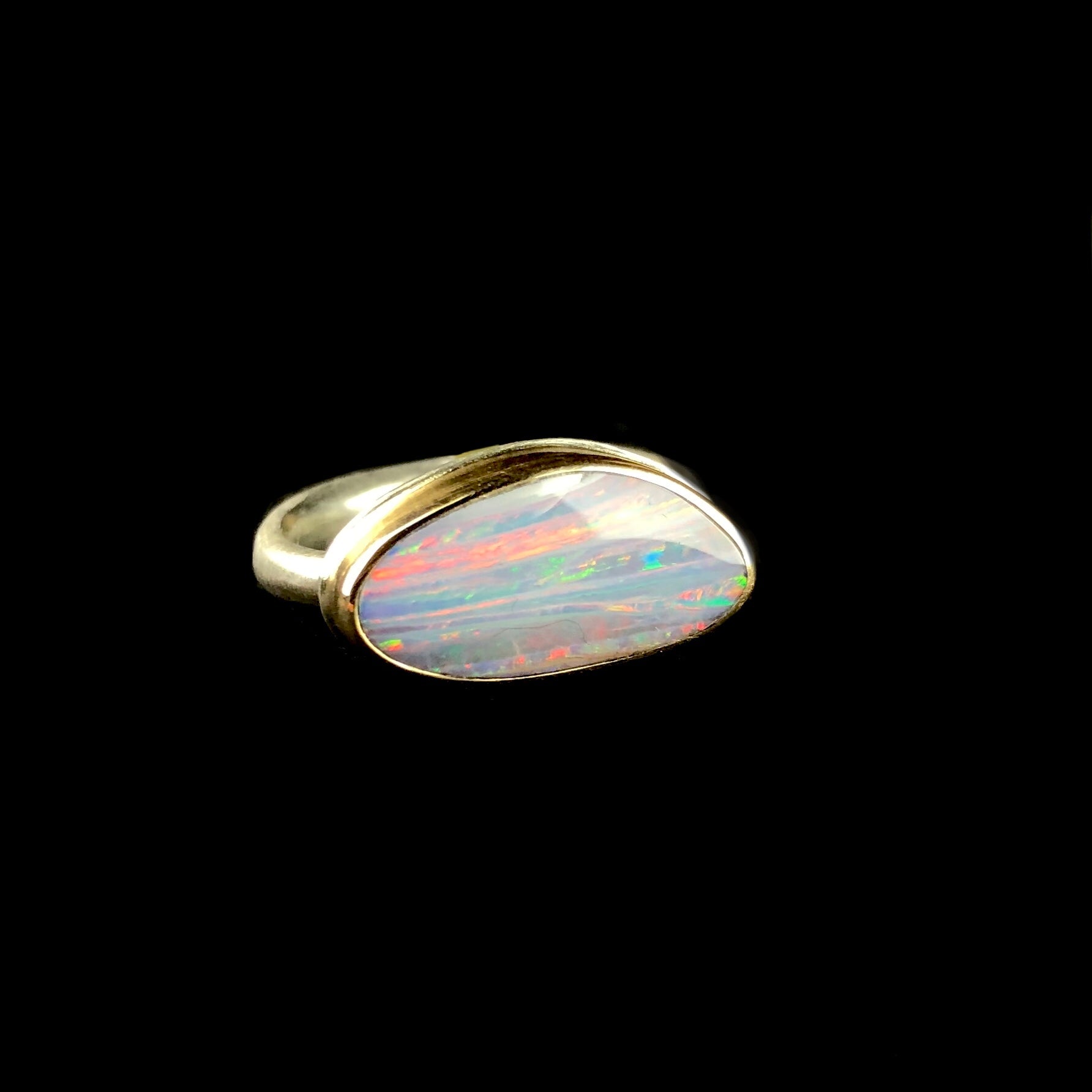 Pink, green, blue, green and smokey lilac colored boulder opal stone ring