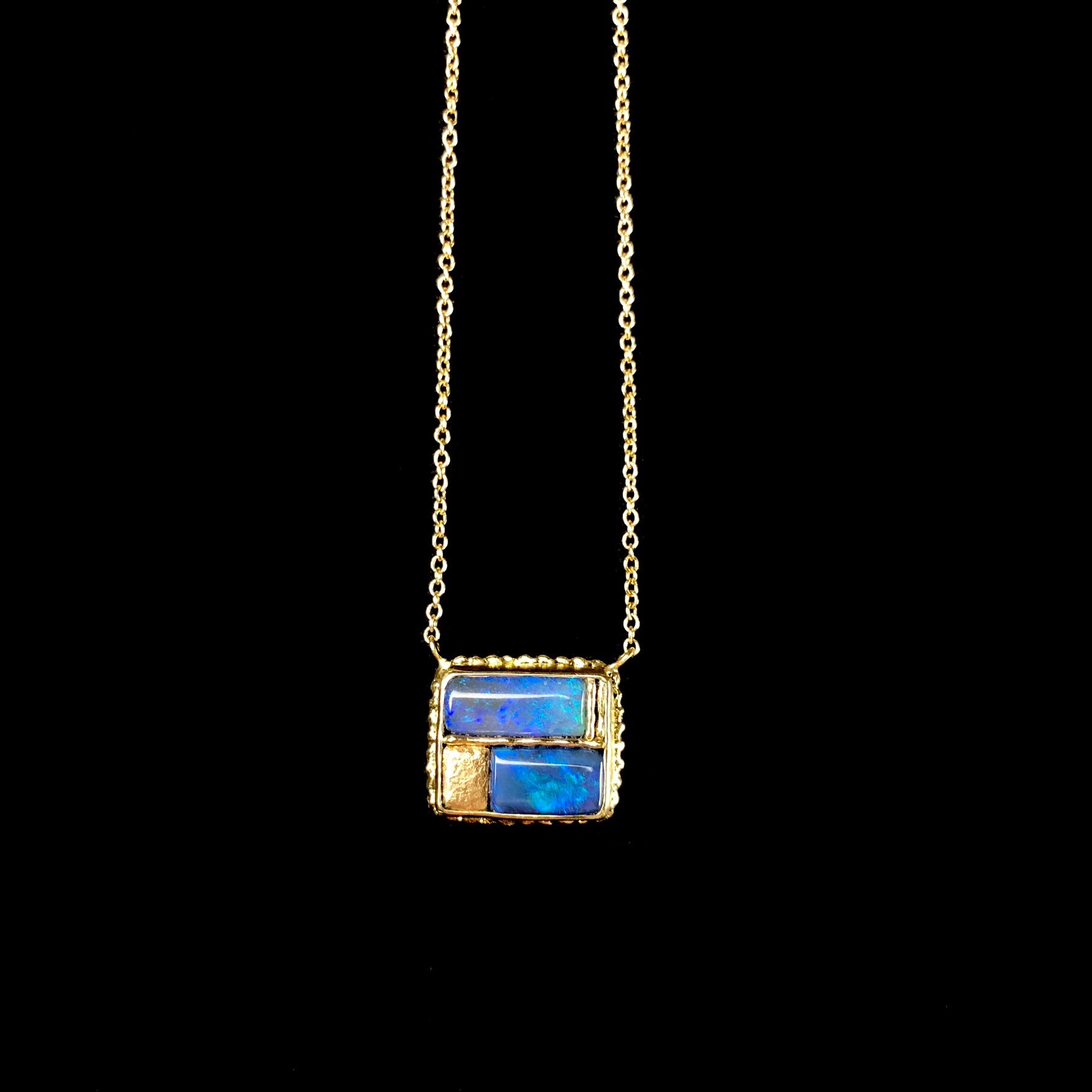Blue and green iridescent opal stones set in gold on chain 
