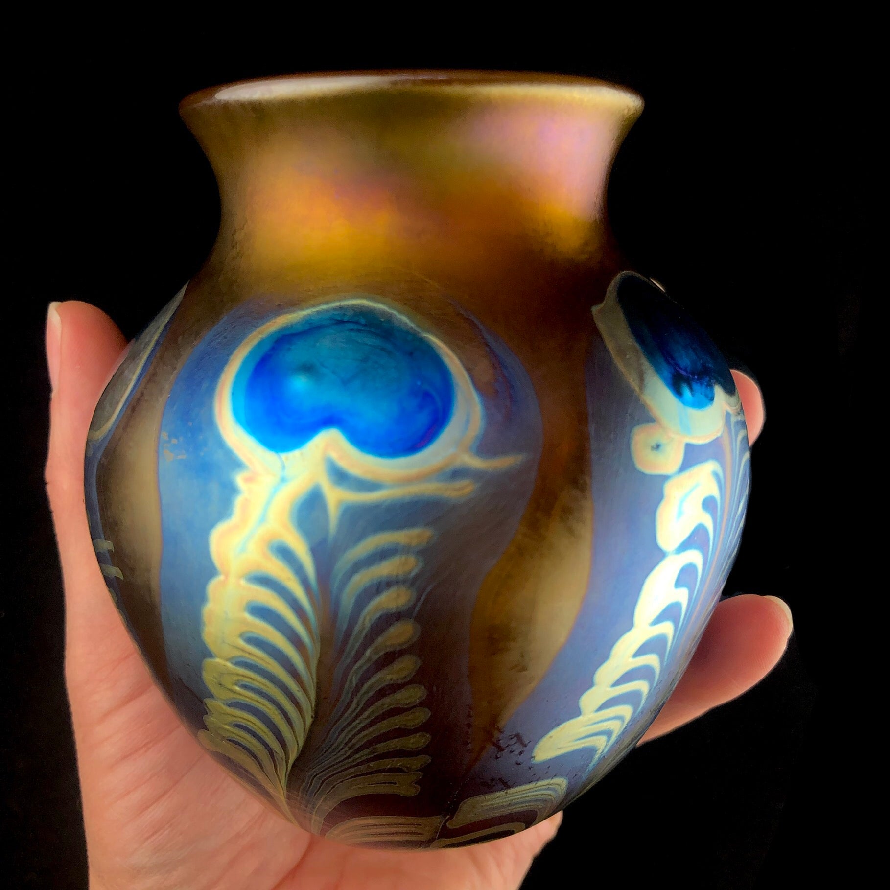 Front view of Amber Peacock Vase in hand