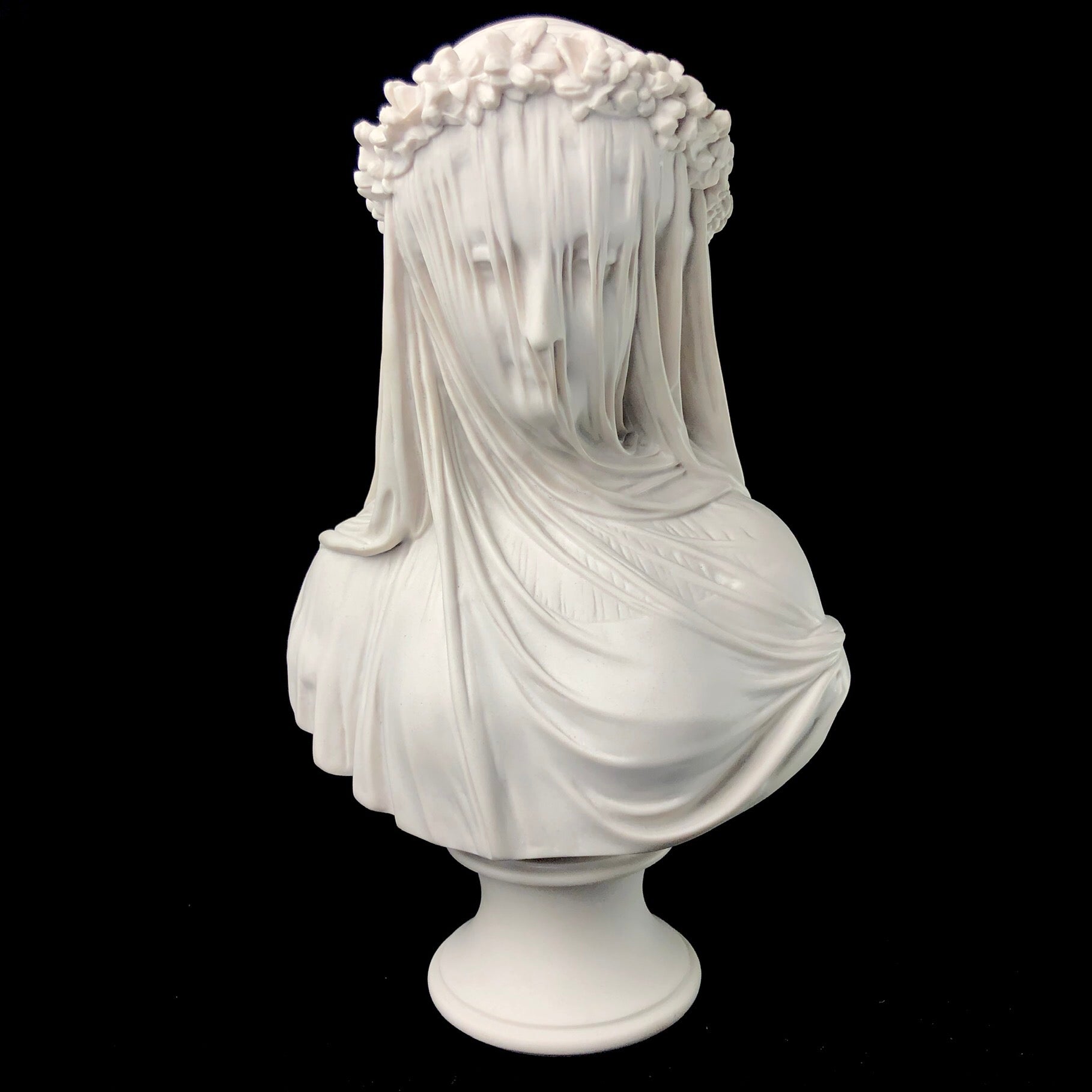 Front view of marble bust depicting a vailed bride with flower wreath around her head