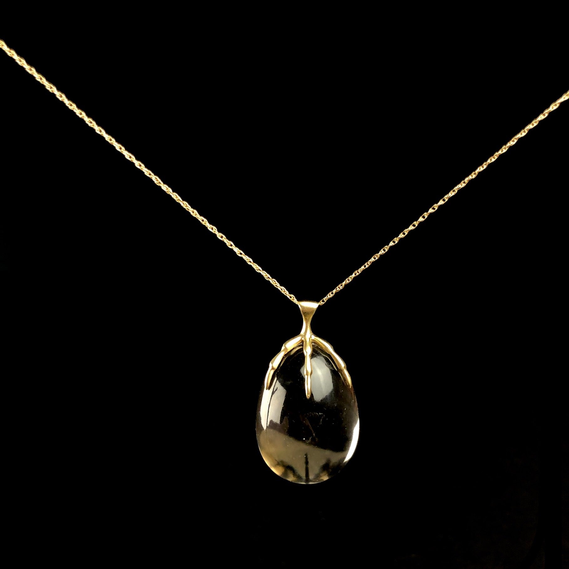 Egg shaped smokey Quartz crystal necklace with gold bird talon setting