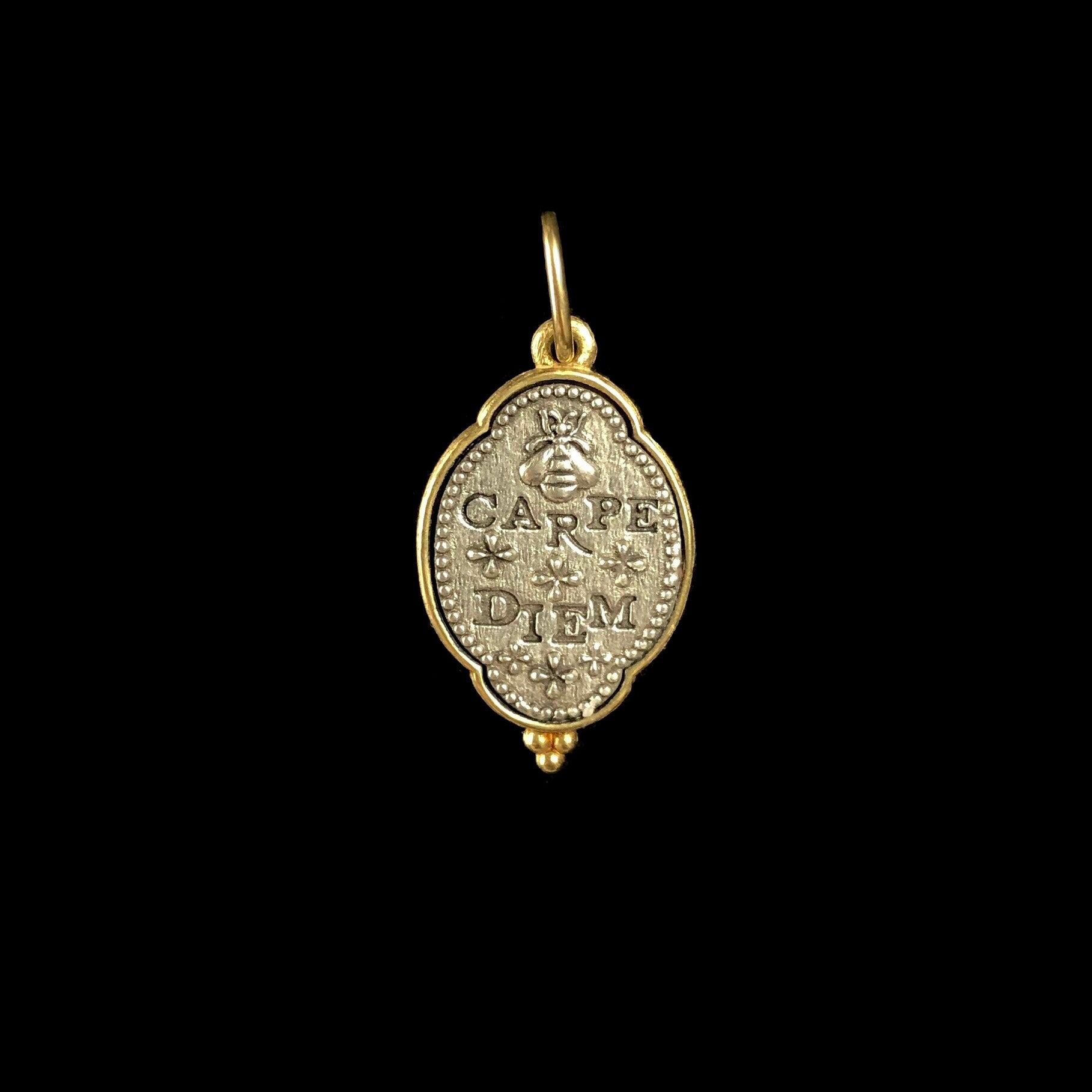 Back side of Queen Bee Charm with relief of a bee and the etched words carpe diem