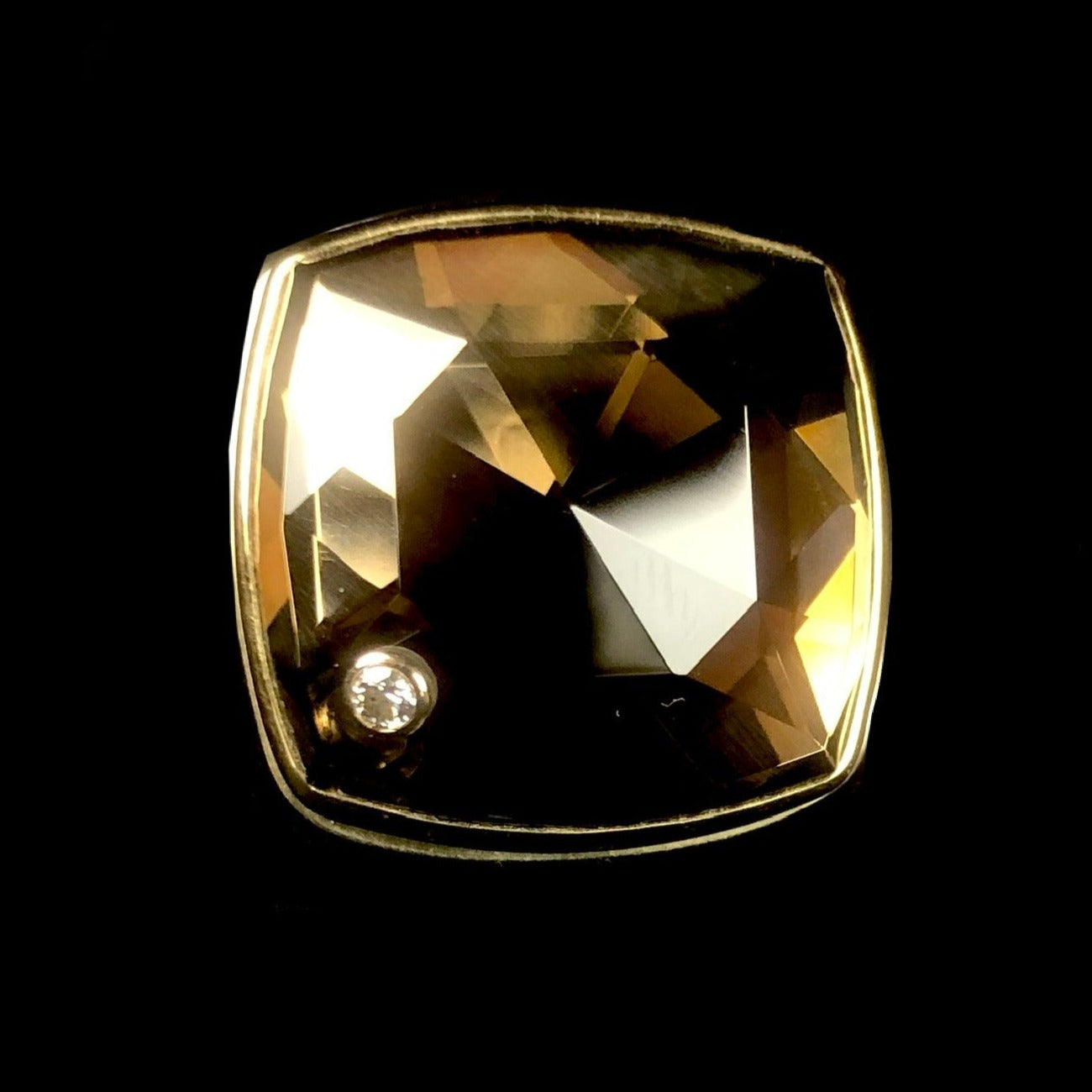 Smokey grey/brown stone ring with shining faceted surface and diamond accent