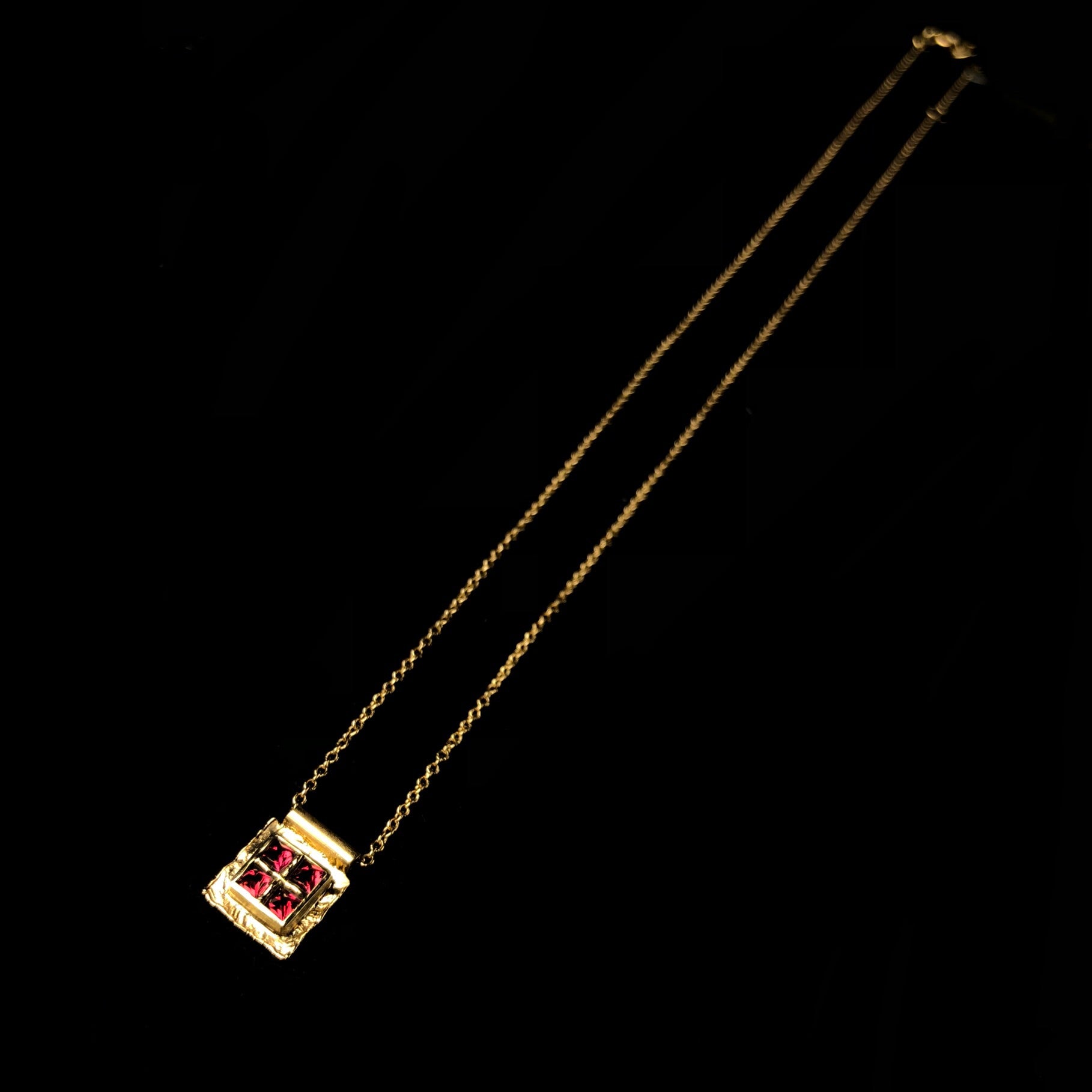 Four red spinel stones in gold platform on chain