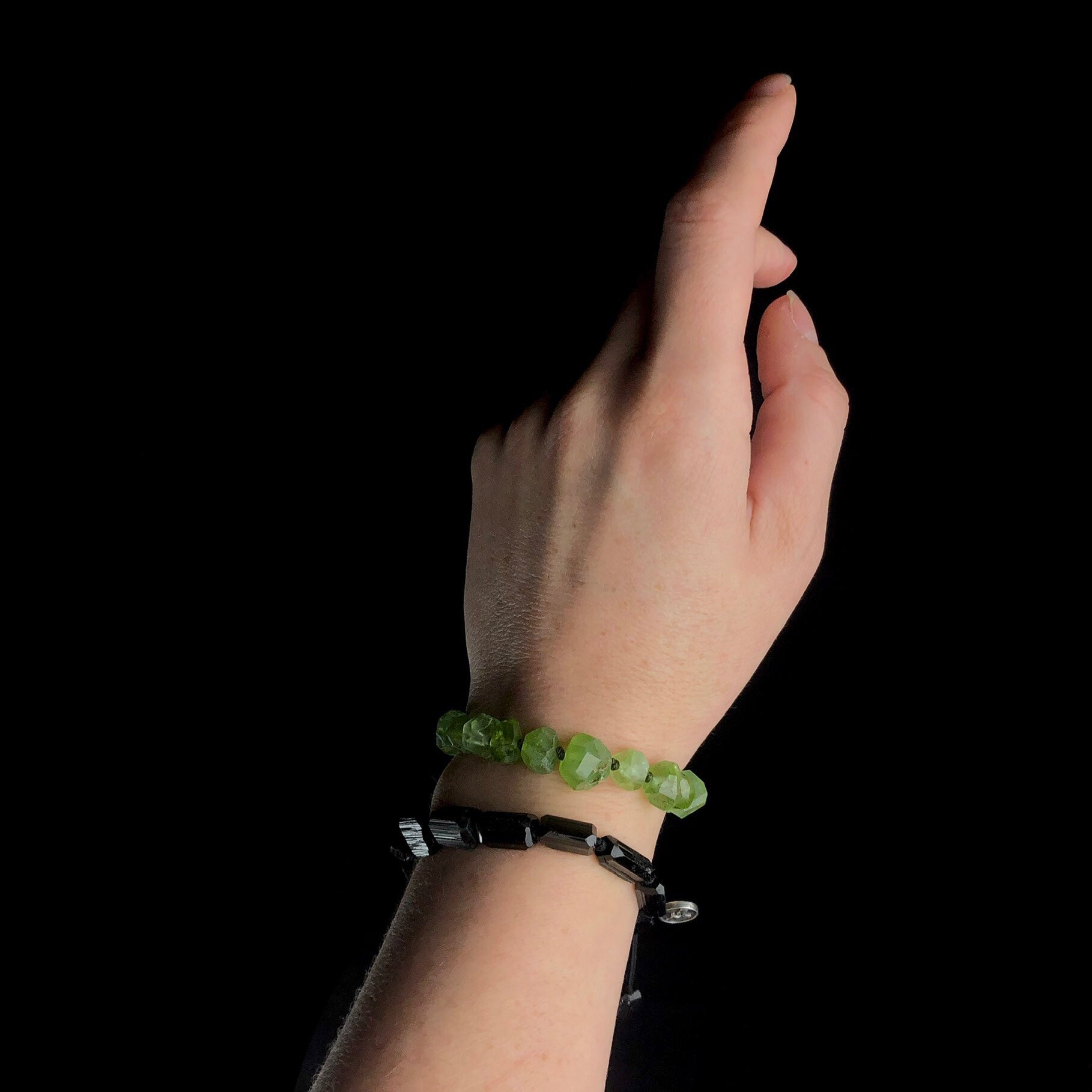 Light green and jet black stone bracelets worn on wrist