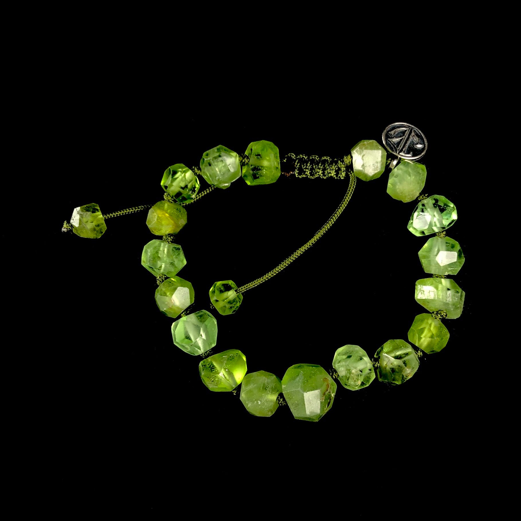Vibrant grass green colored asymmetrically shaped stone beaded bracelet with green knotted cord 