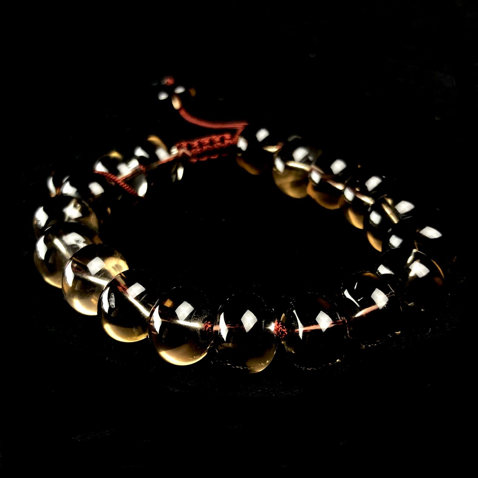 Translucent smokey grey colored stone bracelet with dark brown cording