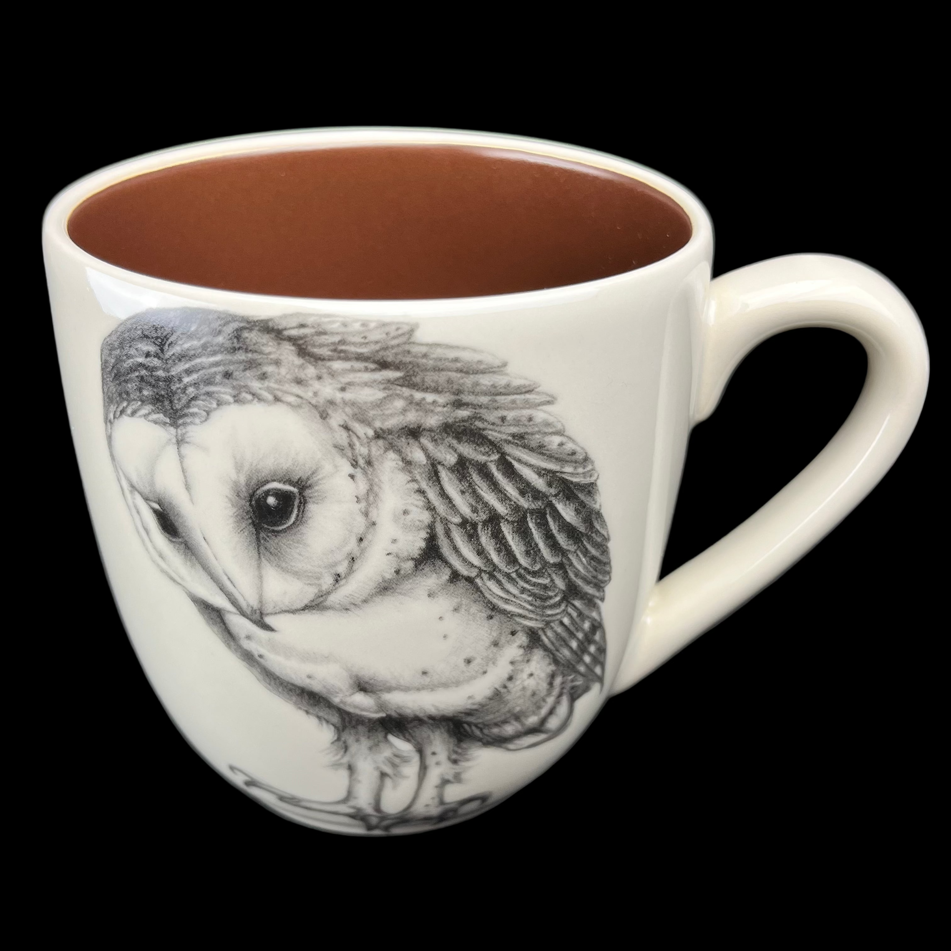 White mug with an owl design on a dark background