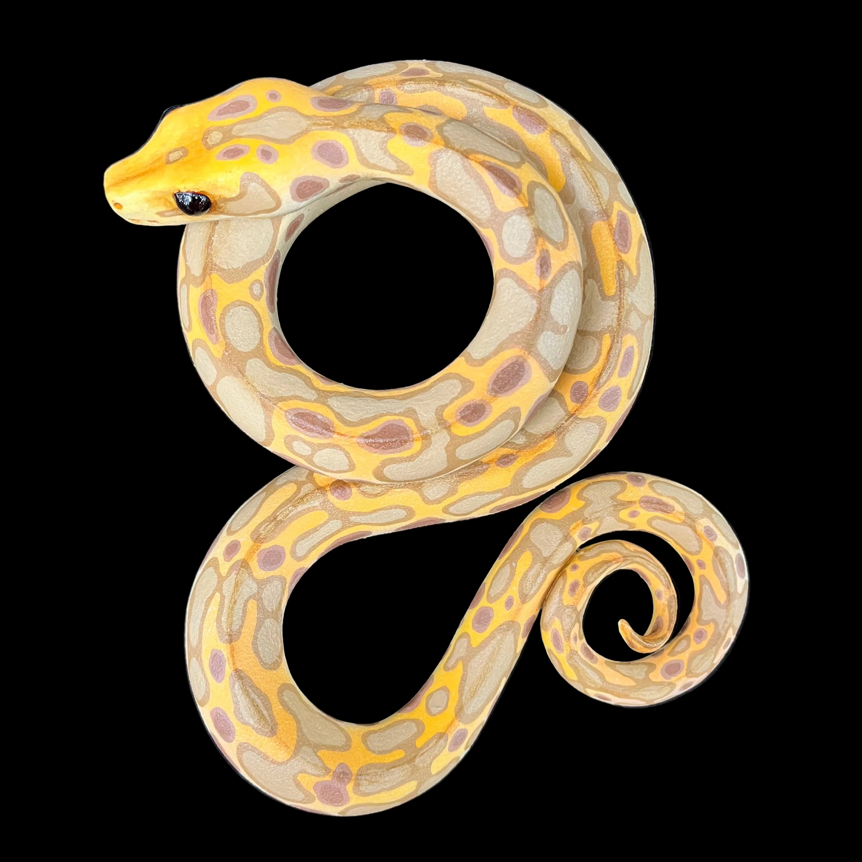 Decorative snake-shaped object with yellow and brown pattern on a dark background