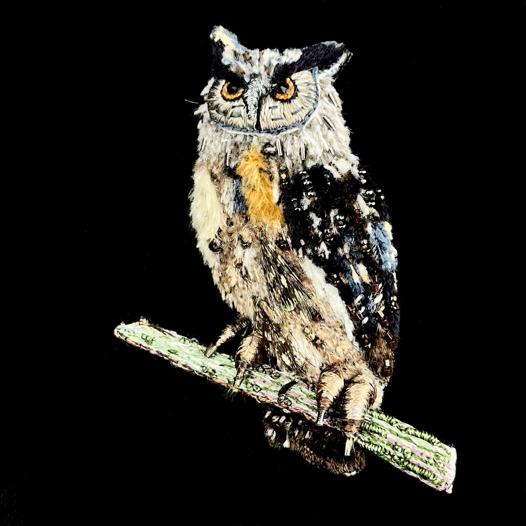 Brown and Blue featherlike thread embroidered owl standing on green branch with sparkling metal and glass bead accents