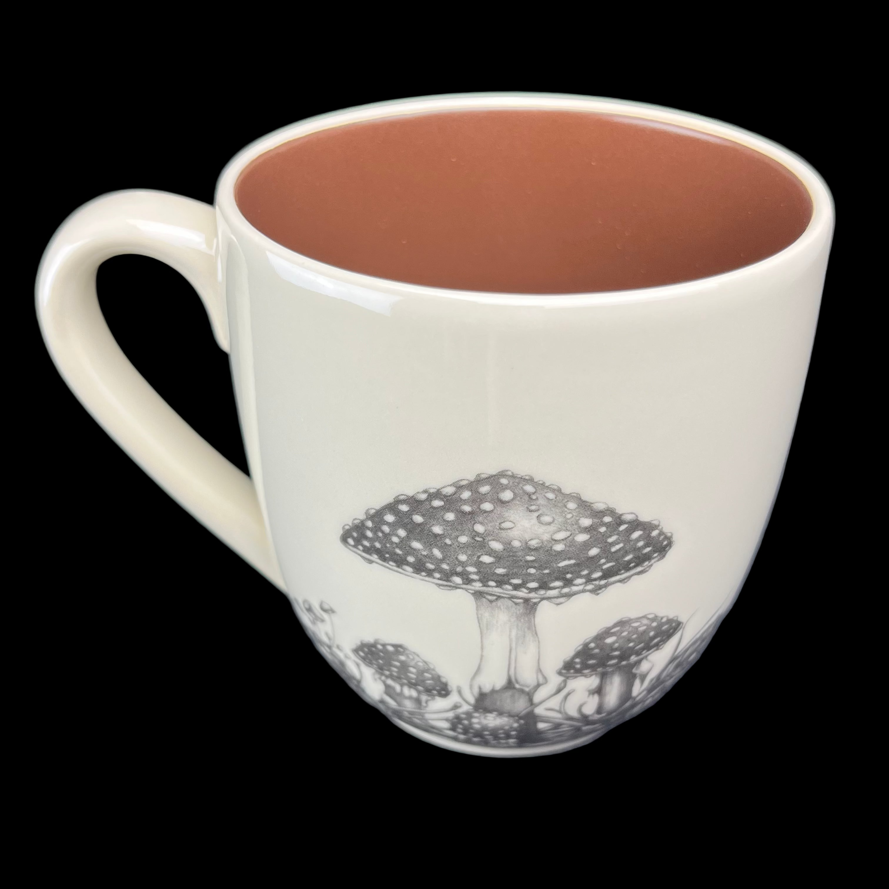 Ceramic mug with mushroom design on a dark background