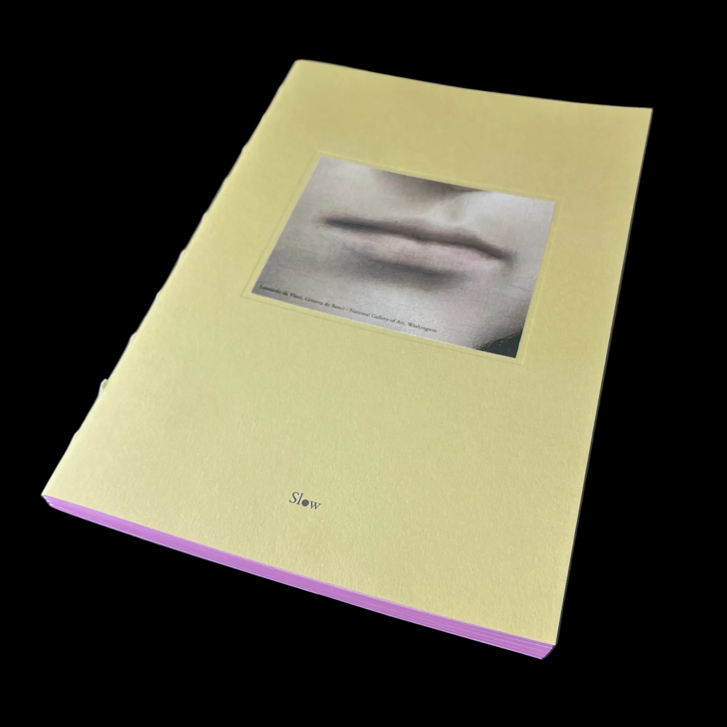 Yellow book with a black and white photo on the cover against a dark background