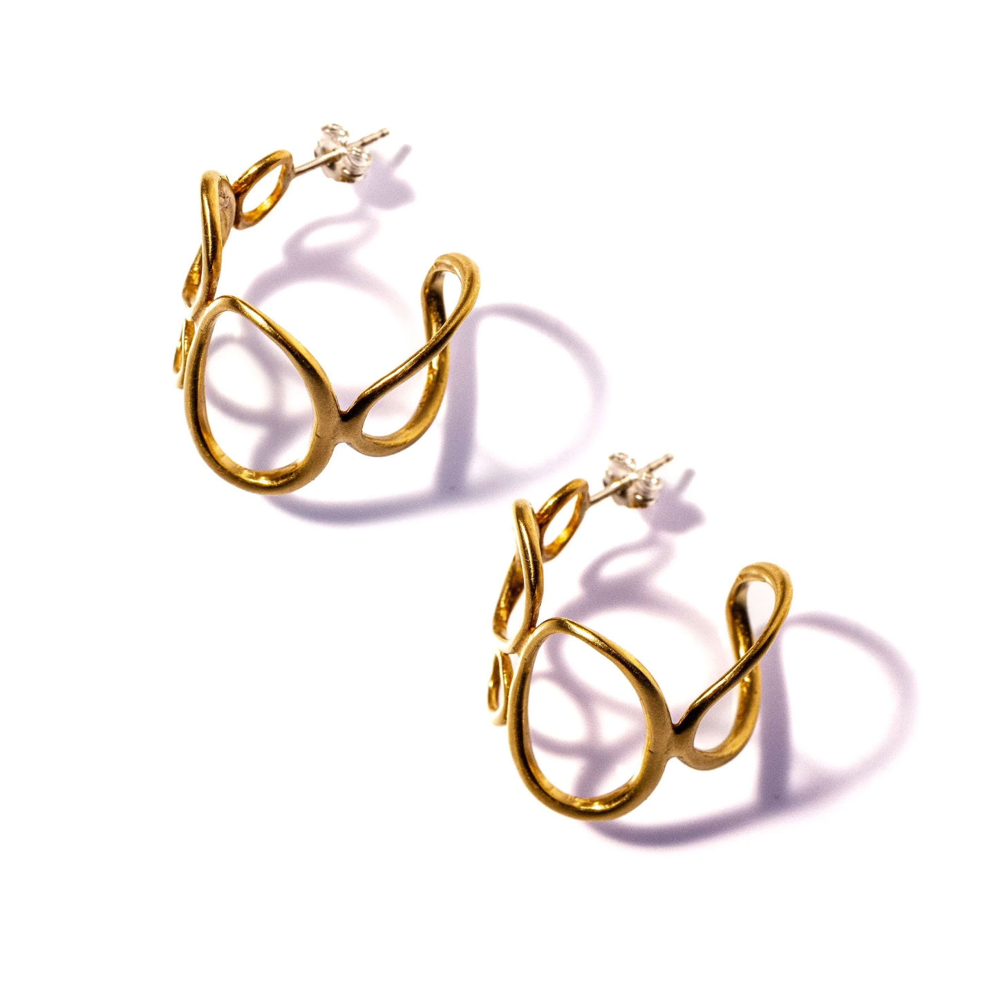 Gold hoop earrings on a white background
