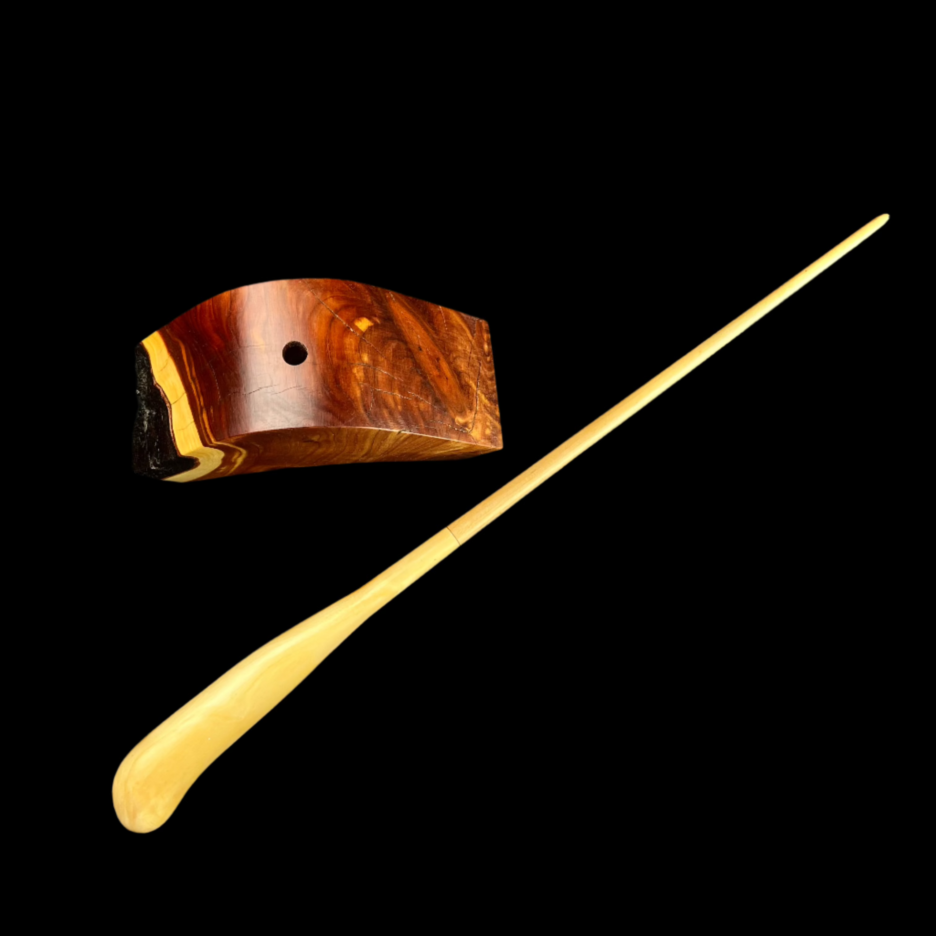 Red Wood base beside light wood wand with handle