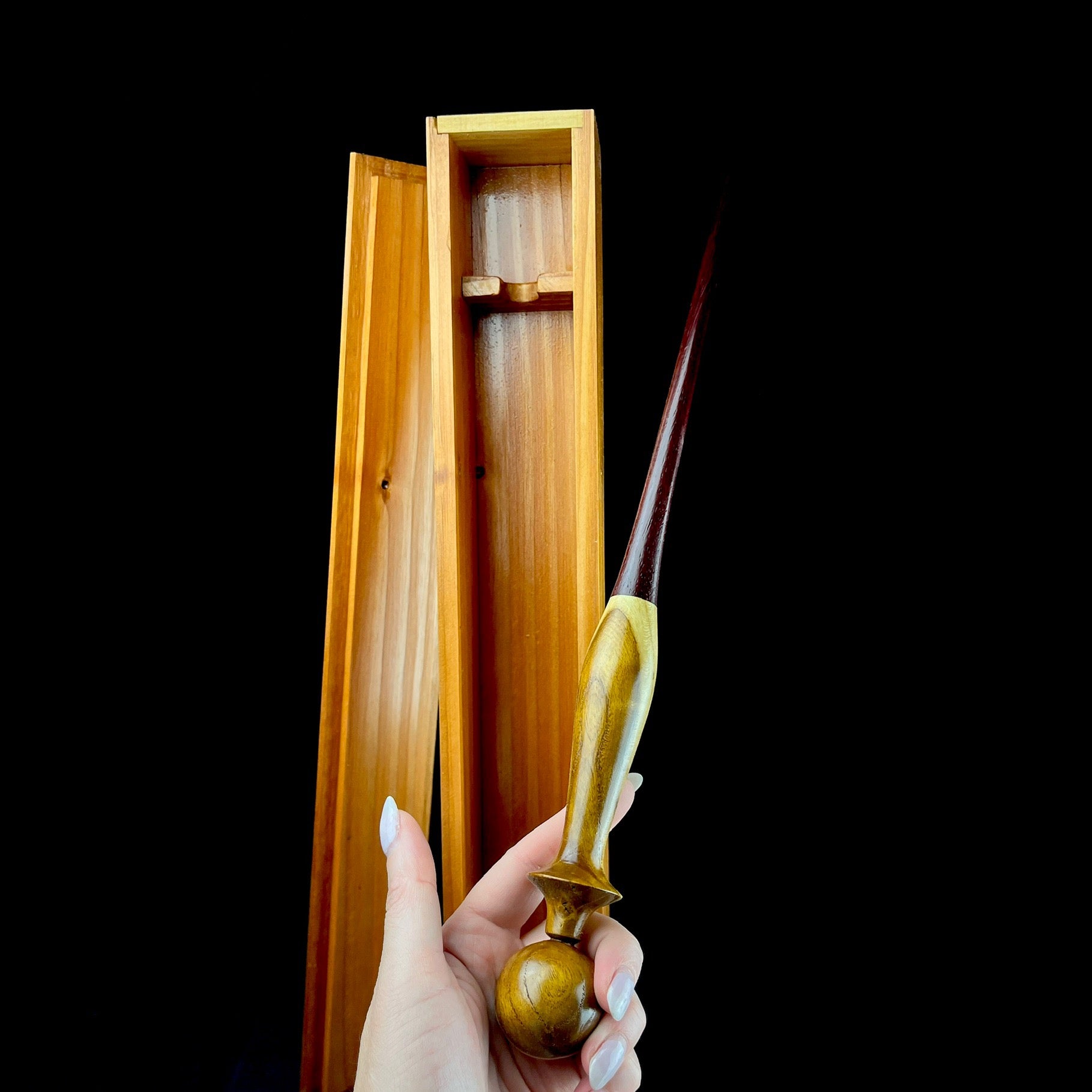 Brown wood wand show in hand
