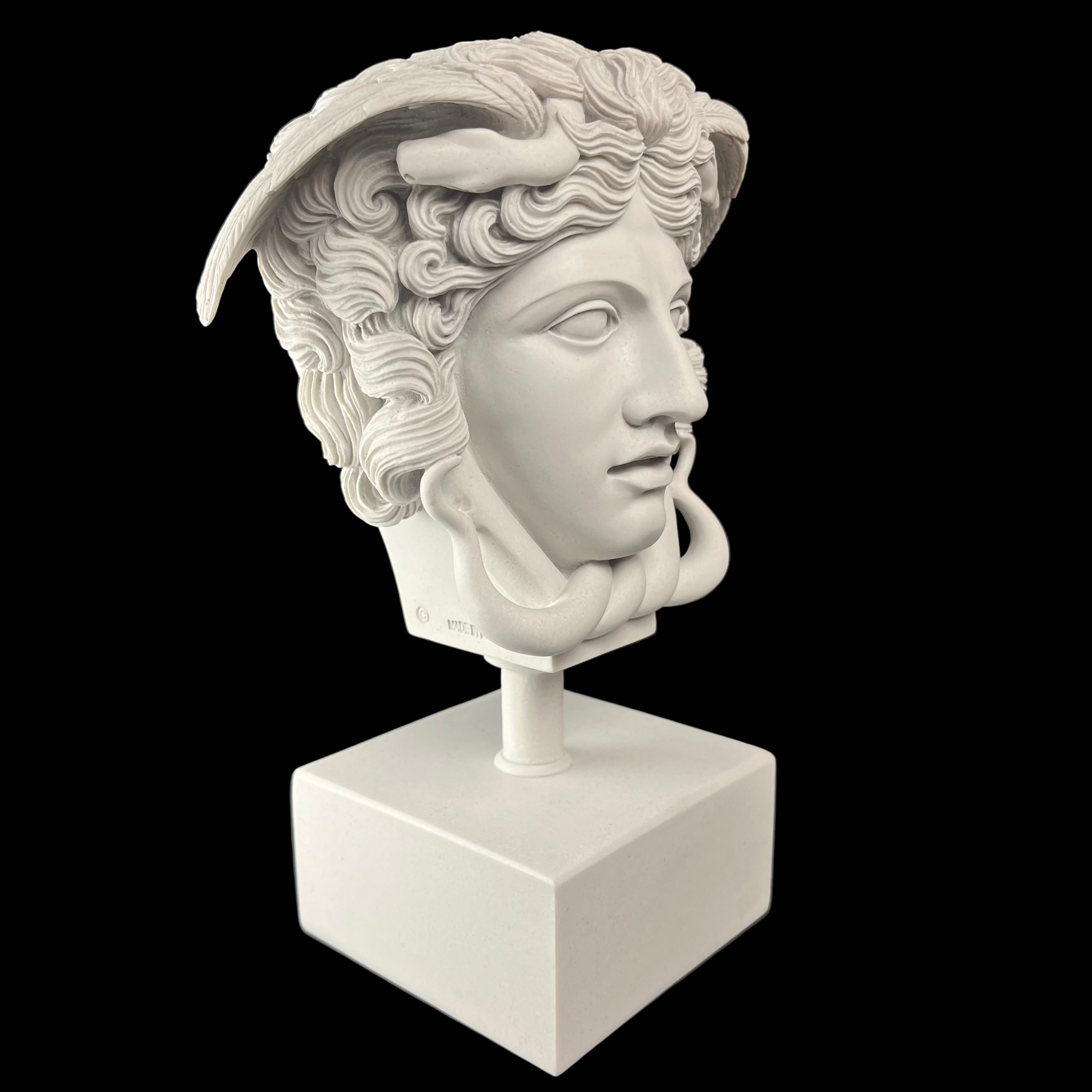 White marble bust of a classical figure on a black background