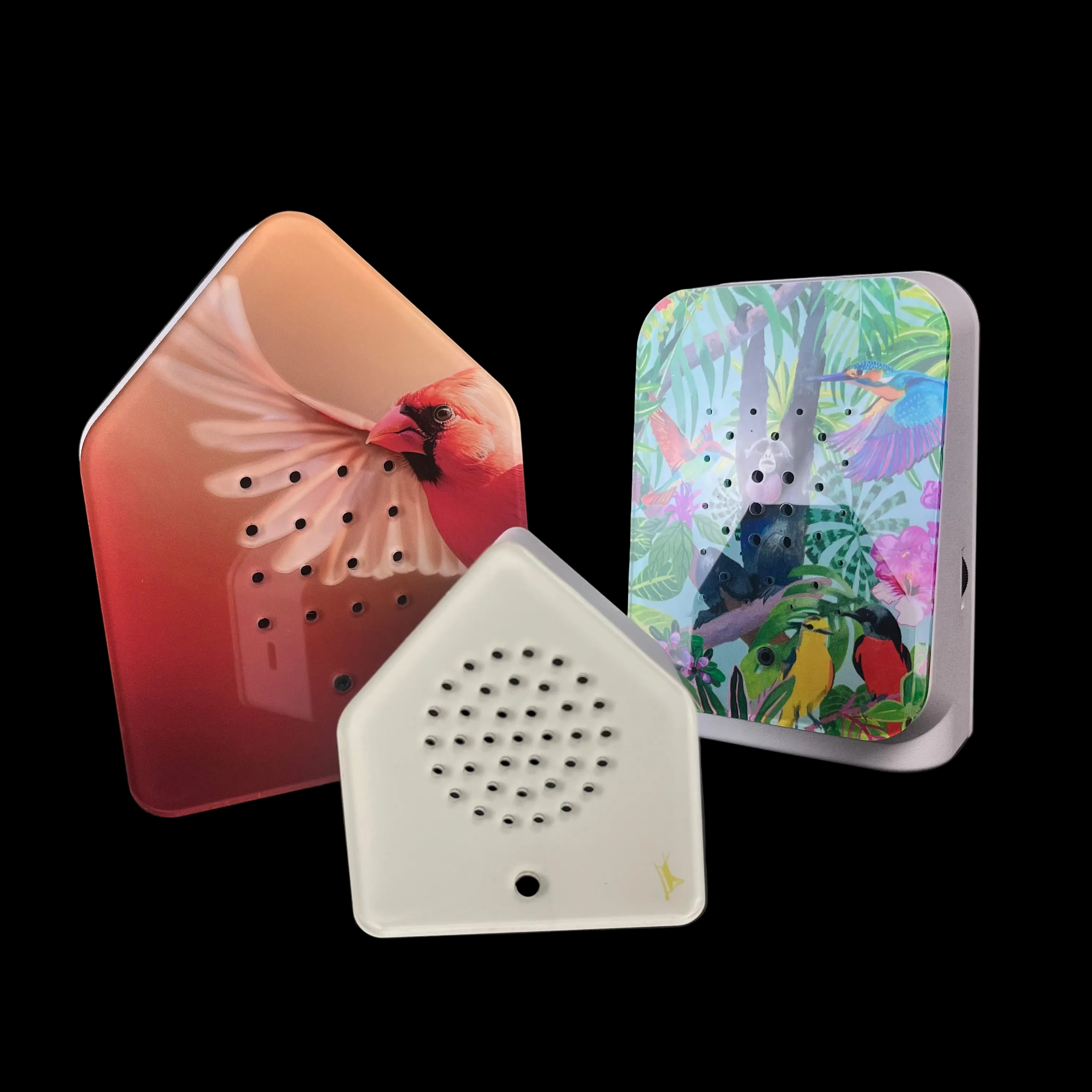 Three decorative items with floral and nature-themed designs on a black background