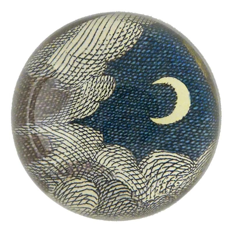Decorative paperweight with wave design and moon on a white background