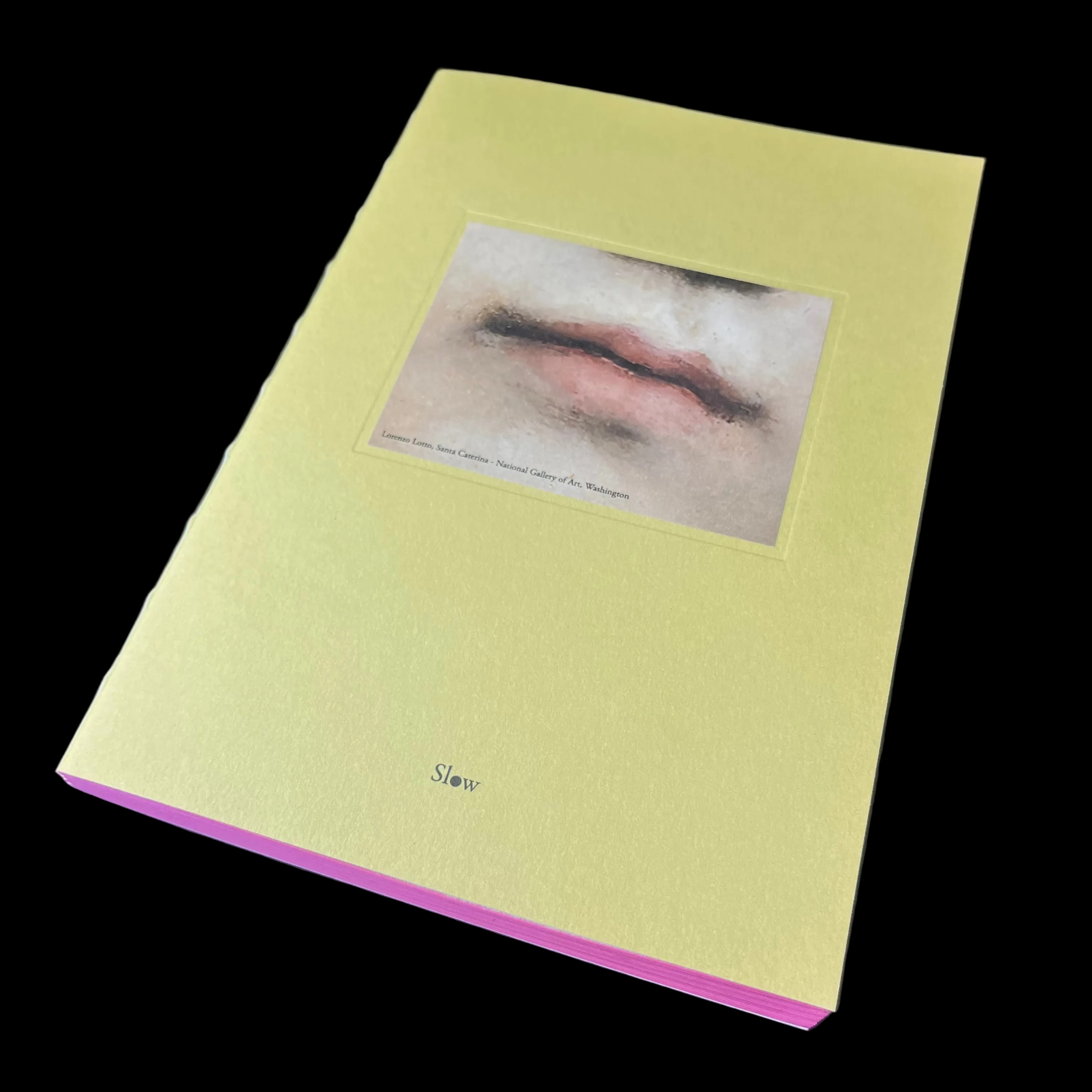 Yellow book with a photo of lips on a dark surface