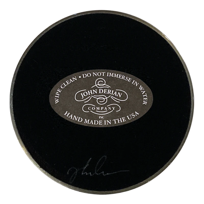 Black round coaster with a gray label featuring 'John Derian Company' text on a white background.