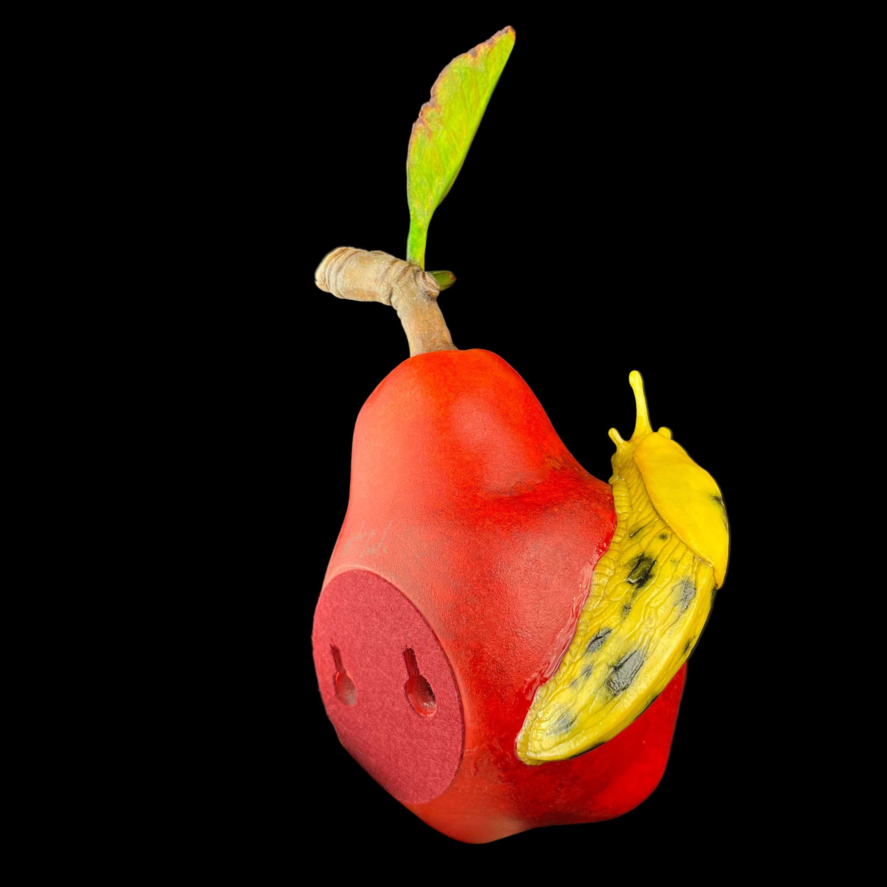 Red pear-shaped object with a yellow slug on a black background