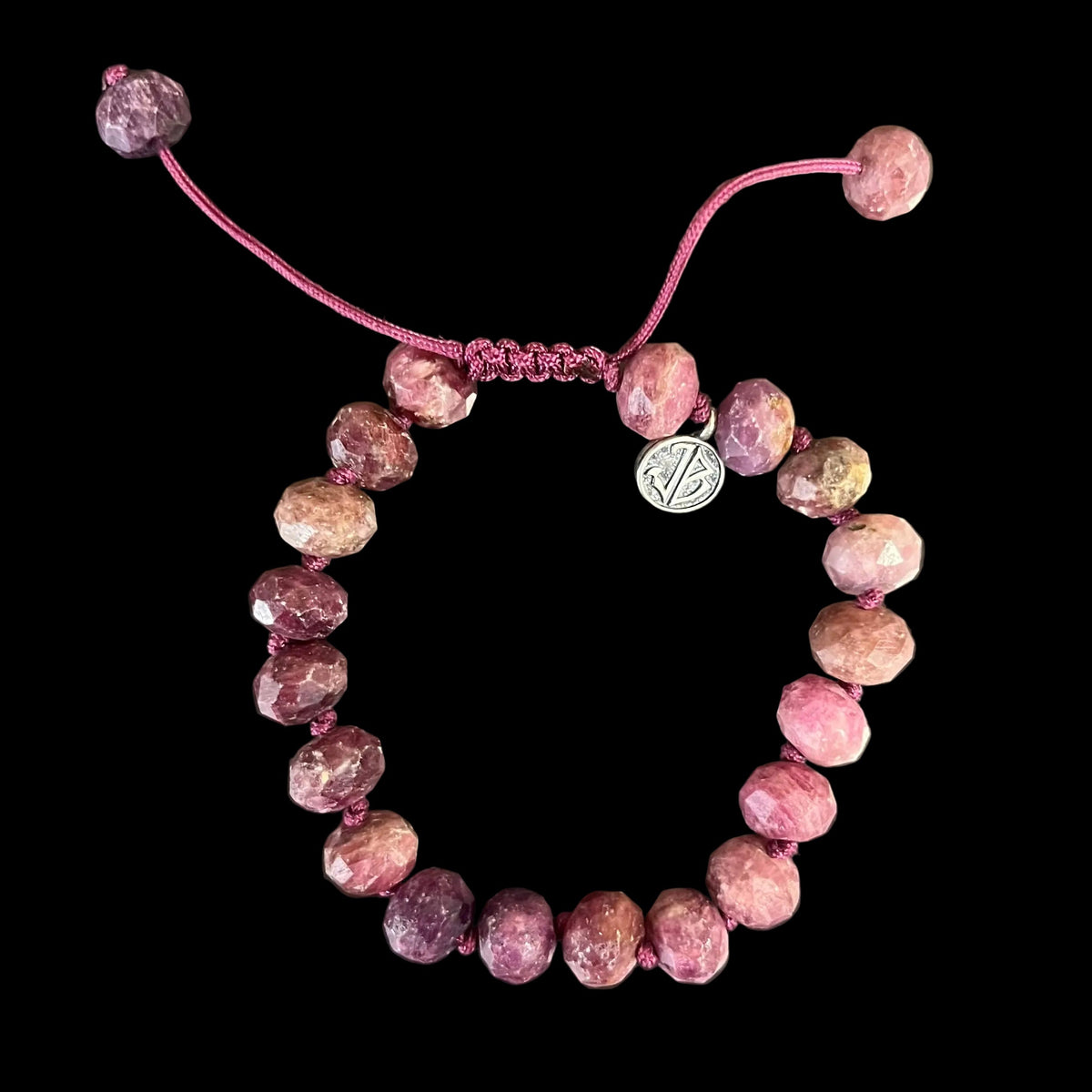 Light pink faceted stone bracelet with knotted cord and closure 